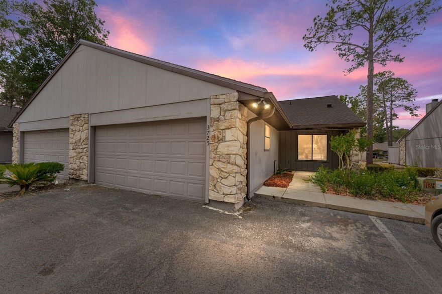 One or more photos are virtually staged. THIS VERY OPEN AND SPACIOUS 2 BED/2 BATH END UNIT WITH VAULTED CEILINGS, TWO PORCHES AND A TWO-CAR GARAGE is unique among attached homes in Mile Run. Situated across the street from Mile Run's clubhouse, pool, playground and tennis courts, this home puts all of the community's amenities at your fingertips. There are also picnic tables and majestic trees on the street, making it among the most desirable of locations in Mile Run. The attached homes on this street are single family homes so the land conveys with the home, making it easier to obtain financing than for other communities in Gainesville. The home includes recently installed light wood flooring throughout the living room and bedrooms. A handsome fireplace is the focal point of the very large living/dining room. A substantial screened porch is attached to the living room, providing an additional area for entertaining, enjoying fresh air, and taking in the sun. The kitchen is a warm and inviting space with ample countertops, a pantry and a built-in desk area. Large glass windows and skylights provide plenty of natural light throughout the home. Both bathrooms feature new fixtures, lighting and commodes. This home is especially well-suited for older individuals or those with physical issues. Ramps are located at the front door and in the garage, allowing effortless entry into the home which has wide doors and very open areas that are accessible via wheelchairs. If not desired, the ramps are easily removed. Located in a highly-rated school zone, this home is perfect for families as well. It is close to shopping, entertainment, grocery stores and parks. The University of Florida and Santa Fe College are just 15-20 minutes away. Don't miss this very well cared for, low maintenance property on your tour of homes in NW Gainesville. New roof installed in Aug. 2025. Offered at $280,000.