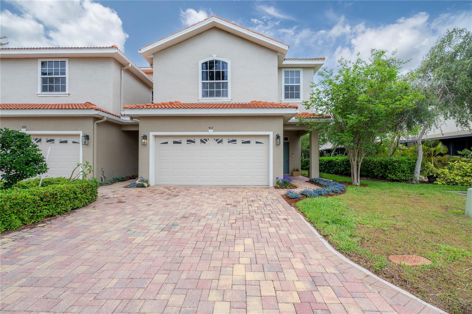 You will be impressed by all that this home has to offer! A rare package since you have it all in this a 3-bedroom, 2.5-bath, 2-car garage, with backyard, two-story tasteful townhome in a gated community with a pool. Built in 2014, the property shows like a model home. Meticulously maintained by its original and only owner, it has been upgraded with both builder design options and thoughtful post-purchase enhancements, creating a stylish and inviting interior. Perfectly situated in the quiet heart of the community, this corner unit features seven additional windows that fill the home with natural light and is steps from the pool. Step inside to be delighted by a spacious, open floor plan on both levels. The bright kitchen is a true highlight, showcasing top-of-the-line upgrades, quartz countertops, a large peninsula table with seating, solid wood 42” cabinets with crown molding, all-new hardware, under-cabinet lighting, a French-door refrigerator, double-oven range, 2021 Insinkerator Quiet Series disposal, built-in desk with drawers upgrades, and a generous pantry. Wood floors run throughout the first floor, while upstairs you’ll find an oversized loft with the upgrade of the entertainment wall and pre-wired sound system. The brand-new primary shower features a frameless glass enclosure and tiled walls, while bathrooms throughout have quartz counter-tops, custom tile floors and accents around the master jetted tub. Storage and organization are maximized with customizable built-in ELFA shelving in the pantry, closets, and garage (complete with workbench), all professionally installed by The Container Store. A spacious covered lanai opens to your private backyard retreat, which can be paved and fenced with low hedges. Additional upgrades include: builder’s light fixtures replaced by hi-end custom light fixtures, upgraded outlet and light fittings throughout, upgraded Kohler faucets throughout, extra recessed lights upgrades in the common areas and stairs, laundry room cabinet, sink and folding table upgrades, Nest thermostat. Other features are: lanai screen extends past the building / covered area, under-stairs storage, tile roof, brick-paved driveway, 2024 exterior paint, and a new 2023 A/C blower motor. The home’s thoughtful design, modern upgrades, and prime location make it ideal for both relaxation and entertaining. While it provides a peaceful private retreat, it is also just minutes from coffee shops, restaurants, shopping, Safety Harbor, Tarpon Springs, and the beaches. Come visit, you’ll be enchanted from the moment you arrive!