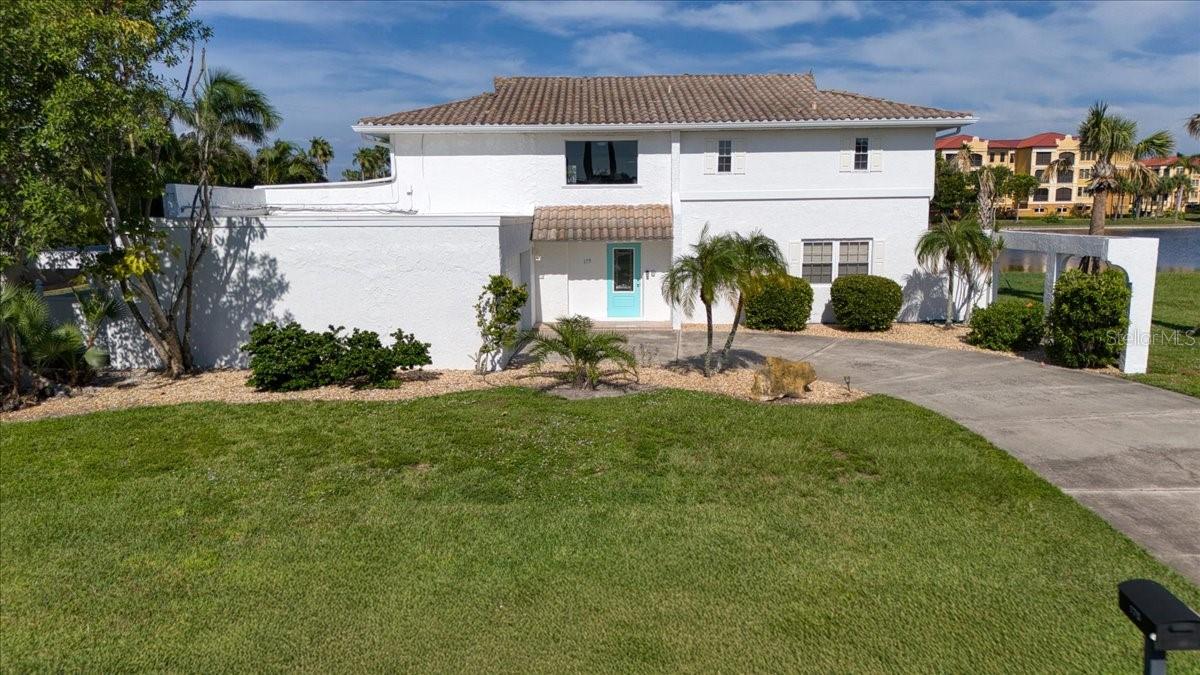 Statuesque & Impressive Two-Story Waterfront Home in Punta Gorda Isles! Experience breathtaking water views from the moment you step inside this expansive 4-bedroom, 5-bathroom residence, offering over 3,000 sq. ft. of living space and an attached 2-car garage. Upon entry, you’re greeted by an elegant staircase and an open-concept design featuring a spacious living room, dining area, and three sets of impact glass sliders that open to the expansive outdoor living area—complete with a 30 x 13 in-ground pool and breathtaking water views. Designed for the Florida lifestyle, the seamless indoor–outdoor flow is perfect for entertaining. The main level features two generously sized bedrooms, each with its own ensuite bathroom. The well-appointed kitchen boasts granite countertops, stainless steel appliances, a breakfast bar, and an adjacent dining space. A first-floor laundry room with washer, dryer, cabinetry, and laundry sink adds convenience, while an abundance of natural light fills the home. Upstairs, the open layout continues with a sunlit living area, built-in bar, and French doors leading to a covered outdoor deck. The enormous primary suite offers spectacular water views, two luxurious ensuite bathrooms, and expansive closet space. A second large upstairs bedroom with a private full bath completes the second floor. Perfect for hosting family, welcoming winter guests, or enjoying peaceful waterfront living, this home offers unmatched comfort and style. Ideally located just one mile from Ponce De Leon Park and minutes to golf, Fishermen’s Village, and historic downtown Punta Gorda’s shopping, dining, and waterfront parks. Close to boat ramps, fishing piers, art galleries, farmers markets, and more!