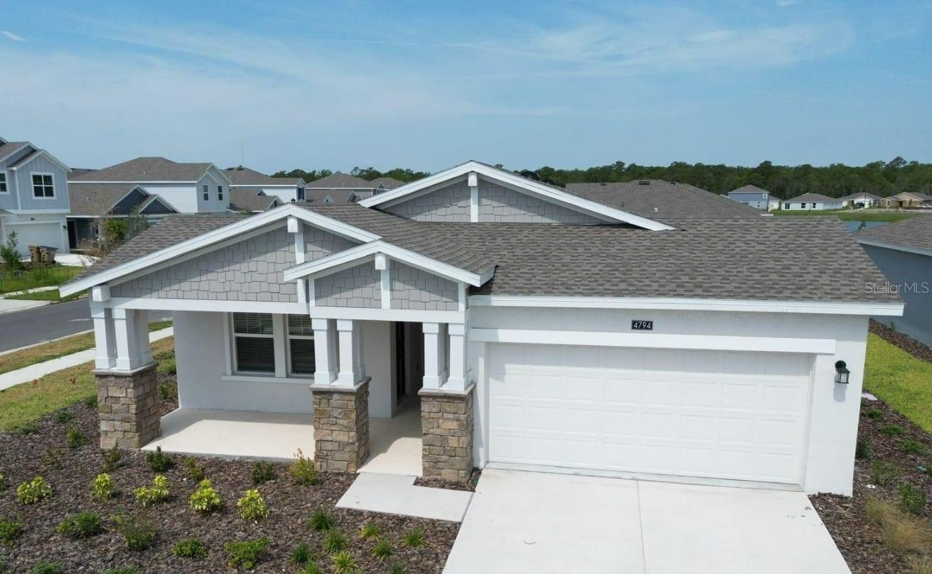 Beautifully designed new construction home in the desirable Westview community of Poinciana, Kissimmee. This spacious single-family residence offers 3 bedrooms plus a versatile bonus room that can serve as a 4th bedroom or a dedicated home office, along with 2 full bathrooms and a 2-car garage — blending modern elegance with everyday functionality. The open floor plan features a stylish kitchen with granite countertops, stainless steel appliances, and a large island that flows seamlessly into the living and dining areas, perfect for entertaining or relaxing with family. The expansive owner’s suite boasts a walk-in closet and a private bath for ultimate comfort.
Set on a desirable corner lot, this home enjoys abundant natural light, enhanced privacy, and exceptional curb appeal. The extended driveway accommodates two additional vehicles, with extra guest parking along the side. Step outside to a private patio, ideal for morning coffee or evening gatherings. Move-in ready, exceptionally spacious, and perfectly located — your dream Kissimmee home awaits!