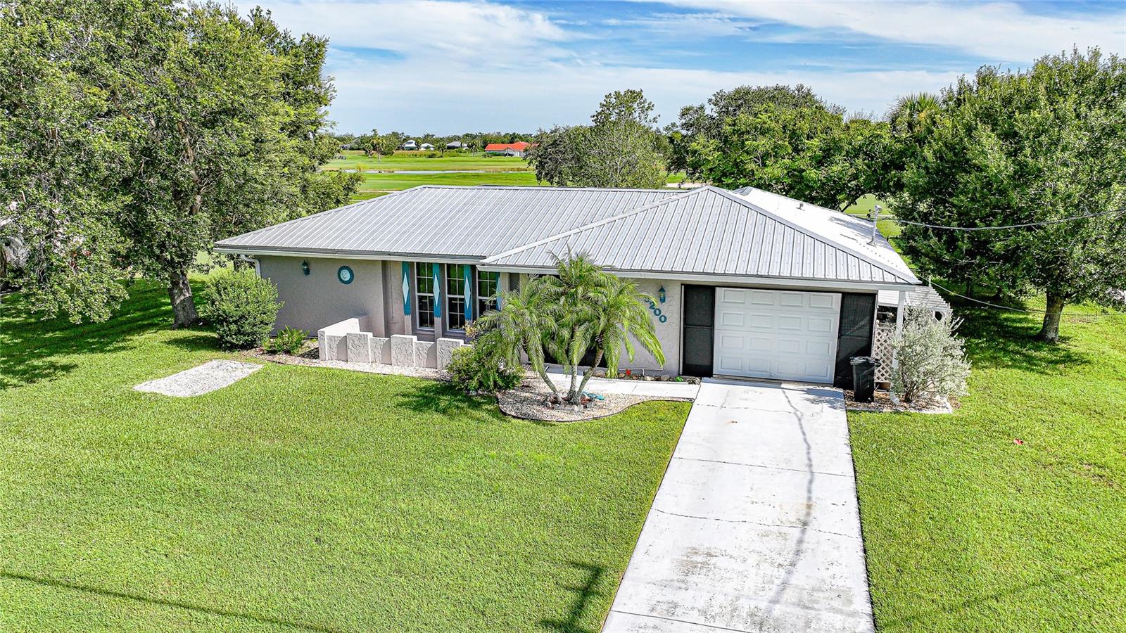 Discover this beautifully updated 2-bedroom, 2-bathroom home with 1,128 sq. ft. of living space, perfectly situated on nearly a half-acre lot (0.46 acres) right on the golf course. Offering the ideal blend of modern upgrades and Florida lifestyle living, this property is a rare find with no HOA fees and the peace of mind of being outside of a flood zone. Step inside to find a completely renovated interior featuring a brand-new kitchen with sleek cabinetry, modern countertops, and new appliances. The home also boasts new flooring throughout, updated electrical, and bright, inviting living spaces designed for comfort and functionality. The primary suite offers a private retreat with its own bathroom, while the guest bedroom and second full bath provide plenty of room for visitors or a home office. Outside, you’ll fall in love with the expansive backyard that opens to tranquil golf course views. A sparkling private pool with a new pool pump and heater (2023) invites you to enjoy year-round relaxation and entertaining. The yard is fully fenced, offering both privacy and space for pets or outdoor activities. Additional peace of mind comes with a brand-new metal roof (2024), ensuring durability and low maintenance for years to come. With nearly half an acre of land, plenty of upgrades, and a prime golf course location, this home is a standout opportunity for anyone seeking a move-in-ready property without HOA restrictions.