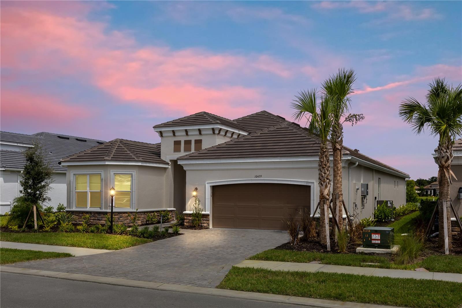 One or more photo(s) has been virtually staged. Several photos have been enhanced with virtual staging. Nestled in the renouned, amenity-packed community of Esplanade at Skye Ranch, this newly constructed Pallazio floor plan is now available for an unfurnished lease. The home enjoys a serene pond view and is designed with a welcoming open layout and high ceilings for ultimate comfort and adaptability. The gourmet kitchen is a chef's dream with a spacious island, ample cabinetry, a walk-in pantry, and a gas stove, all overlooking the tranquil pond. Both the kitchen and family room open through dual sliding doors to a generously sized covered lanai, perfect for seamless indoor-outdoor living. The private primary suite at the rear of the home features an elegant bedroom with bay window pond views, a luxurious bath with dual vanities, an oversized shower with a rain shower head, a private toilet and a large walk-in closet. Guests can enjoy the en-suite second bedroom with a walk-in closet, while the third and fourth bedrooms share a full bath on the opposite side of the home. A flexible 14-by-14 room offers additional space for an office, den, or hobby area. The two-car tandem garage provides extra depth at 32 feet on one side, ideal for storage, a home gym, or larger vehicles. A refrigerator, washer and dryer will be installed shortly.
As a resident of Skye Ranch, you will have access to outstanding amenities, including The Hub, which features a café, indoor basketball and pickleball courts, a climbing wall, a cutting-edge fitness center, an exercise studio, a game room, locker rooms, and a Junior Olympic-sized pool. The community also offers a second pool, splash pad, hot tub, outdoor tennis and pickleball courts, playgrounds, a dog park, and scenic trails for walking and biking, plus Rendezvous Park and Turner Park for recreation and events. The newly opened Skye Ranch School serves grades K–6, with plans for future expansion through middle school. Just a short drive down Clark Road leads to the sandy beaches and vibrant shopping and dining experiences of Siesta Key Beach.