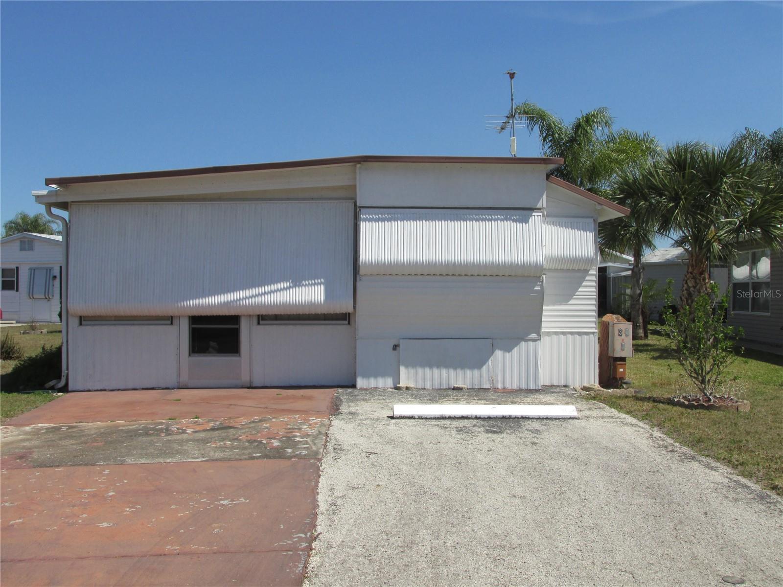 This furnished home is located in the 55+ pet friendly community of Saddlebag Lake Resort, where you own the land. NEW HVAC INSTALLED 5/9/2025 with 10 year transferrable warranty! On the main floor you'll find a spacious living room and a room at the back for your overnight guests, while upstairs is the kitchen and dining room combo and the owners suite with pass-through bathroom. The Florida room at the back is large enough to store the golf cart, which comes with the home. Situated on a nicely landscaped corner lot, there is also a two-car driveway for off road parking and a shed which houses the washer and dryer, with space for all your tools. Come for the winter, or live here year round, either way you will feel like you're on vacation every day, with the crystal clear community pool, screen enclosed hot tub, fitness center, rec room with pool tables and saunas, a driving range, tennis, pickle ball and shuffleboard courts, horse shoes, and of course the lake where you can spend your days boating and fishing. The low HOA includes your water, sewer and trash pick-up, plus use of all the amenities. This value priced home won't last long so call now for your private tour!