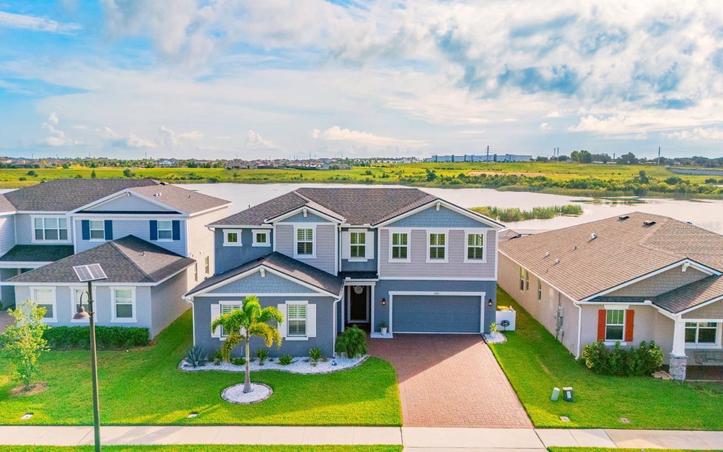 One or more photo(s) has been virtually staged. Welcome to this stunning and meticulously maintained 6-bedroom, 4-bathroom home in the highly sought-after gated community of Waterbrooke in Clermont, FL. Situated on a premium lakeview lot, this spacious residence offers 3,241 sq ft of beautifully designed living space with upgrades that impress at every turn.
Step inside and you'll immediately notice the luxury vinyl flooring in the main living area. The heart of the home opens to an expansive living room, gourmet kitchen with stainless-steel appliances, built-in oven and large island, and formal dining room ideal for both entertaining and everyday living. Sliding glass doors with motorized blinds lead to the extended screened-in lanai with panoramic cage — perfect for relaxing or entertaining while enjoying serene water views. The beautifully landscaped yard with concrete curbing and rain gutters adds to the home's impeccable curb appeal.
The main floor features a dedicated office, a full bedroom and bath, and a luxurious primary suite complete with ensuite bathroom and customized walk-in closet with built-in shelving.
Upstairs, you'll find the other 4 bedrooms, all enhanced with beautiful plantation shutters, and a spacious loft area ideal for a second living space, playroom, or media room. Additional highlights include a 3-car garage with epoxy floors, a whole-house water softener system, and modern finishes throughout.
Located in the desirable Waterbrooke community, you’ll enjoy gated security, resort-style amenities, walking trails, and proximity to shopping, dining, and top-rated schools. This home shows like a model—don't miss your chance to make it yours!