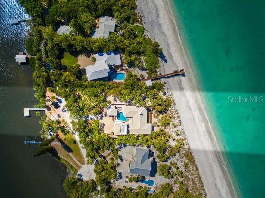 Welcome to 776 North Manasota Key located in Englewood on southwest Florida’s 11 mile island just south of Venice in Sarasota County. Here you will experience the unhurried pace of life with Old Florida ambiance in this gated community, with fewer than 80 properties on the approximately 2-mile private road. This beachfront residence was completely gutted in 2018 and completed in 2020, with all new plumbing, electrical, new shell stone flooring, new appliances, impact doors and windows, and reconfigured to reflect a modern comfortable living space to enjoy for years to come. With 2,960 s.f. of living area, the house sits high on 1.3 acres with over 14 feet of elevation. The main Living area features an open floor plan with comfortable places to gather family and friends; informal dining with views to the gulf. The well designed kitchen is a cook’s dream with plenty of cabinetry and storage and views to the beautiful courtyard salt system pool. Privacy was a consideration in the space planning of the bedrooms: the primary suite encompasses the south wing of the ground floor, with the bedroom opening to a screened porch for relaxing and taking in the magnificent sunset views, while 2 ensuite bedrooms are on the north wing. Upstairs, a large bonus room can function in multiple ways; the large windows offer mesmerizing views of both the bay and gulf views from the access to exterior deck. Enjoy entertaining from the expansive gulf-side Ipe wood deck. Or escape to the beach through stepping stone pathways and choose your spot for taking in the magical sunset views. Here you can stroll the sandy beaches of your own secluded getaway with endless views of the gulf’s warm turquoise waters. Two outdoor showers allow ease of washing sandy toes. Enjoy beach combing for shark’s teeth, seashells and sand dollars or fishing and kayaking from your private dock. Unique to the island is the ability to join the Manasota Key Beach Club, located mid-key, with dining, tennis, pickleball, Bocci. Also convenient on the south end of the key are boutiques, waterside restaurants, water sport rentals for your enjoyment. Two bridges allow easy access to the mainland offerings with proximity to excellent schools, golf courses, restaurants. Paradise awaits you in this truly ready to move into beach home where you can relax and begin making lasting memories to cherish. Furnishings are optional under separate agreement.