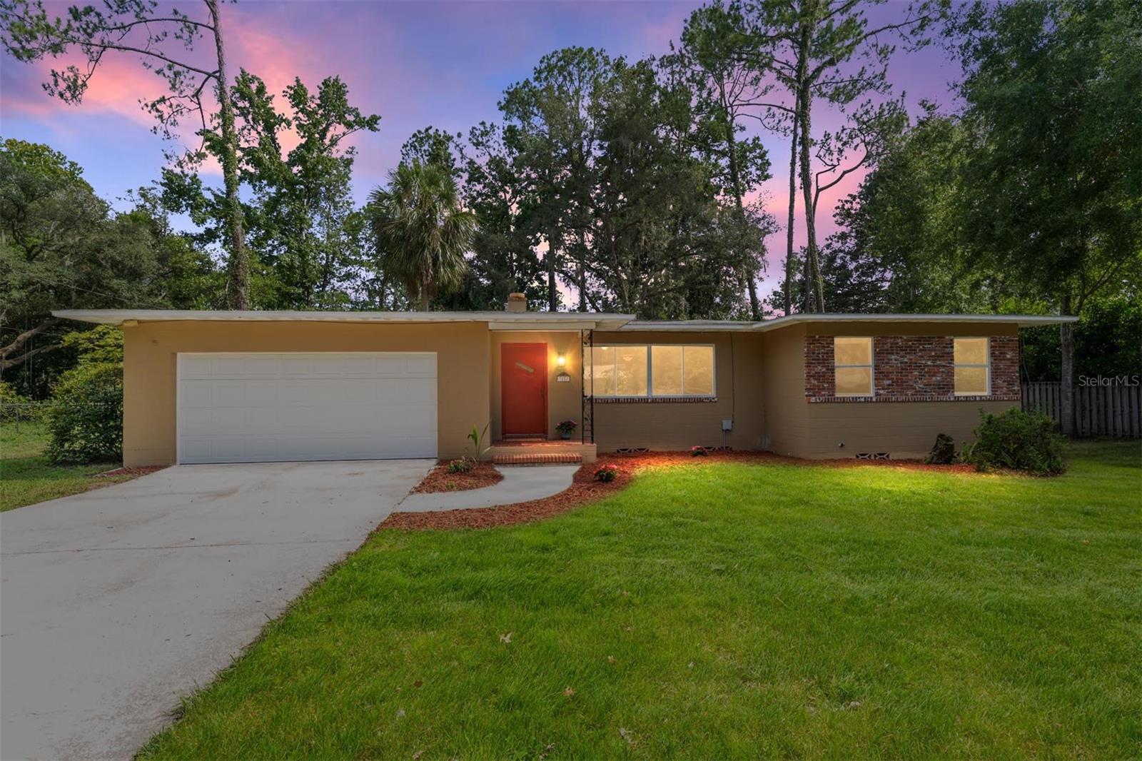 Nestled in the sought-after Fletcher Heights neighborhood, this 3-bedroom, 2-bath home offers 1,679 square feet of comfortable living on a beautifully sized .34-acre lot. Just a short bike ride to the University of Florida, this home blends warmth, classic charm, functionality, and location in one irresistible package. Step inside to a welcoming interior that has been completely painted featuring a spacious living and dining area, along with a sunlit Florida room encased in windows that bathe the space in natural light. The inviting kitchen is both practical and cozy—ideal for everyday living and casual gatherings. All bedrooms are situated conveniently on one side of the home. The primary bath has been tastefully renovated, while the guest bath retains charming vintage tile paired with updated cabinetry and countertops. Step outside to your private backyard retreat, where a brick paver patio and natural landscaping offer tranquility and seclusion—perfect for unwinding or cultivating your green thumb. Located near parks, local shops, and dining, this home combines character and convenience in one of Gainesville’s most desirable communities. This property presents a rare opportunity near UF with no HOA.