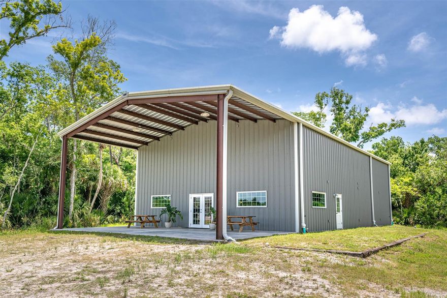 Welcome to Moody Hawk Farm, 22.05 acres named after one of resident hawks that patrol the property. The more time you spend on this property the more it is appreciated through the eyes of endless possibility. Zoned A1 including Agricultural exemption currently in place through a honeybee lease currently at the back of the property. The current owners originally set into motion their dream of having an Agritourism center including expansive opportunities including weddings, winery, overnight lodging, retail sales, recreational activities, tours, reunions, company retreats, holiday event, music festivals, educational workshops, and others! As you meander down the long driveway toward the large 40'x60' barn you are greeted by a 40'x20' covered patio. Continuing onto the double french doors welcoming you to the grand ball room you will be attracted to the 20' ceilings, massive hand-built bar! Highlights include a 4 compartment sink, plumbing for ice maker and beer coolers, 2 instant hot water heaters, 400 amp electric panel with 240 outlets by the stairs for beer making, 19x19 storage room suitable for a walk-in cooler, commercial kitchen and health department compliant, 20x40 upstair room with full bathroom and laundry facilities, ADA compliant bathroom downstairs, and 3 AC units. Outside on the manicured grounds you will find a 46'x21' Carolina carport that includes 2 enclosed bays and one open air bay, 4 wells, 1 potable with water treatment system and others for irrigation, main barn is plumbed for 2 outdoor bathrooms, electric is ran to the workshop/carport area, and mobile chicken coop. The cultivated grounds include 40 persimmon trees, 800 lbs. of turmeric, 250' of blackberry trellis, 30 mulberry trees, 8 Loquats and 50 beehives via Apiary lease along with extensive landscape trees circling the property. Be sure to head down the road behind the back of the main barn where there is cleared area perfect for a possible home site. Ready to make your dreams come true?