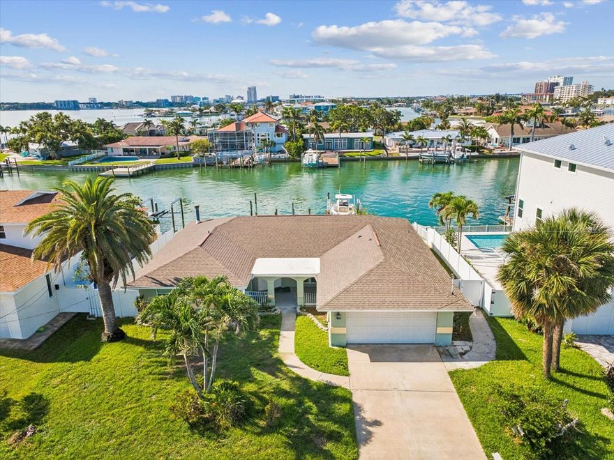 Waterfront living in Island Estates with direct Intracoastal views and true boating convenience. This well-maintained 3-bedroom, 2-bath residence offers the rare combination of updated systems, private dockage, and a location just minutes from Clearwater Beach.

Designed for the Florida coastal lifestyle, the property features a private boat deck with a 10,000-lb lift, separate jet ski lift, and generous docking space — ideal for boating enthusiasts seeking immediate water access. Whether used as a primary residence, second home, or waterfront investment, the dock infrastructure delivers exceptional flexibility and long-term value.

Inside, the open floor plan creates seamless flow between living, dining, and kitchen areas, enhanced by tile flooring throughout for durability and low maintenance. Large windows frame tranquil water views and bring in natural light, while the layout supports both everyday living and entertaining.

Step outdoors to a saltwater pool with heated spa, creating a private backyard retreat overlooking the water. The setting offers both relaxation and the ability to host gatherings with ease.

Major updates provide peace of mind, including:
• Roof replaced in 2019
• Gas tankless water heater installed in 2020
• Boat deck rebuilt in 2023
• New AC system installed in 2025

Located in the desirable Island Estates community, residents enjoy a quiet waterfront neighborhood atmosphere while remaining just minutes from Clearwater Beach, dining, shopping, and local amenities.

Opportunities to secure updated waterfront property with lift-equipped dockage in this location are limited. Schedule your private showing and experience the lifestyle firsthand. The seller has limited knowledge of the property’s current condition as it has been used primarily as a seasonal residence. Buyer must independently verify all measurements, specifications, and property details.

Schedule your private showing to explore this waterfront opportunity.