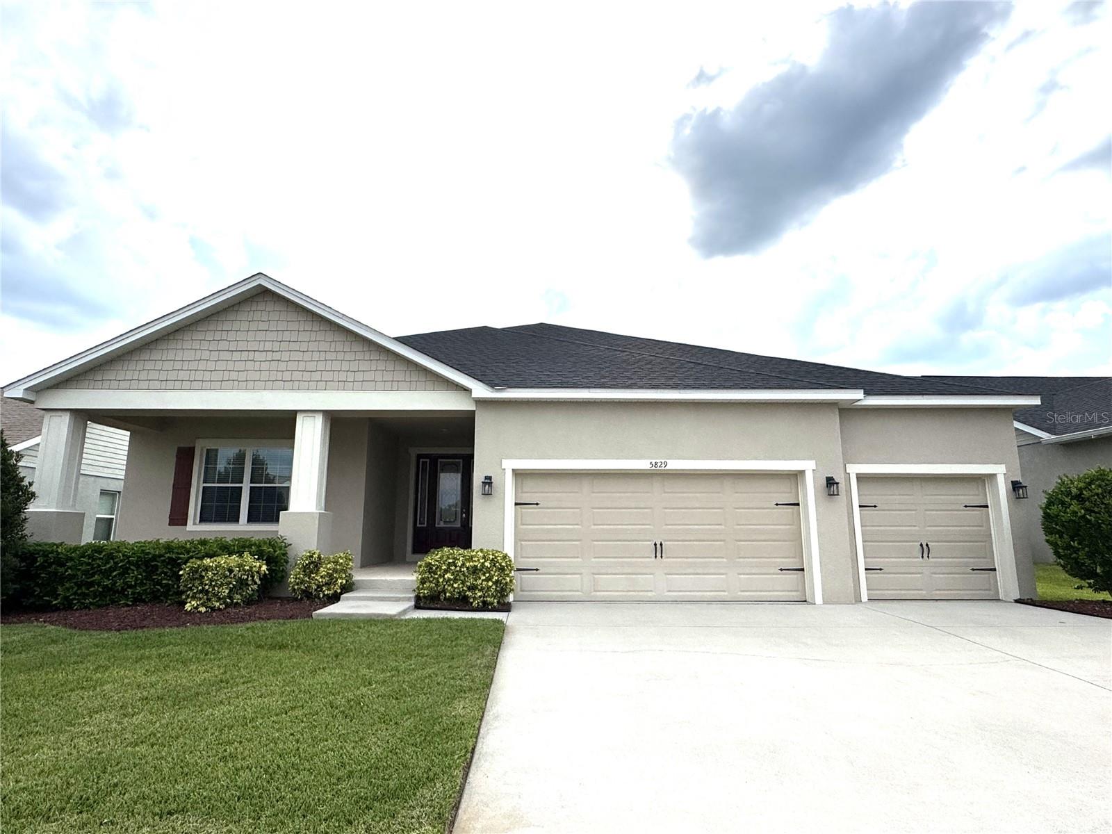 Southeast Lakeland Gated Community of Highlands Grace. 4-bedroom, 3-bath with Office (could be 5th bedroom). Spacious Floorplan with tile and luxury vinyl plank flooring, no carpet. Beautiful custom features and millwork. Kitchen with granite countertops, oversized island, stainless-steel appliances, extended cabinetry with built-in desk, glass tile backsplash, and oversized walk-in pantry. Split Bedroom Plan. The primary bedroom offers walk in shower, dual vanities and walk-in custom closet. This home includes an in-law suite with a private bath, perfect for guests or multigenerational living. Two additional bedrooms with guest bath along a hallway off the kitchen. 3 Car Garage extended. Screen-enclosed lanai and fully fenced in yard. Lawn care included. Schedule your showing today!
