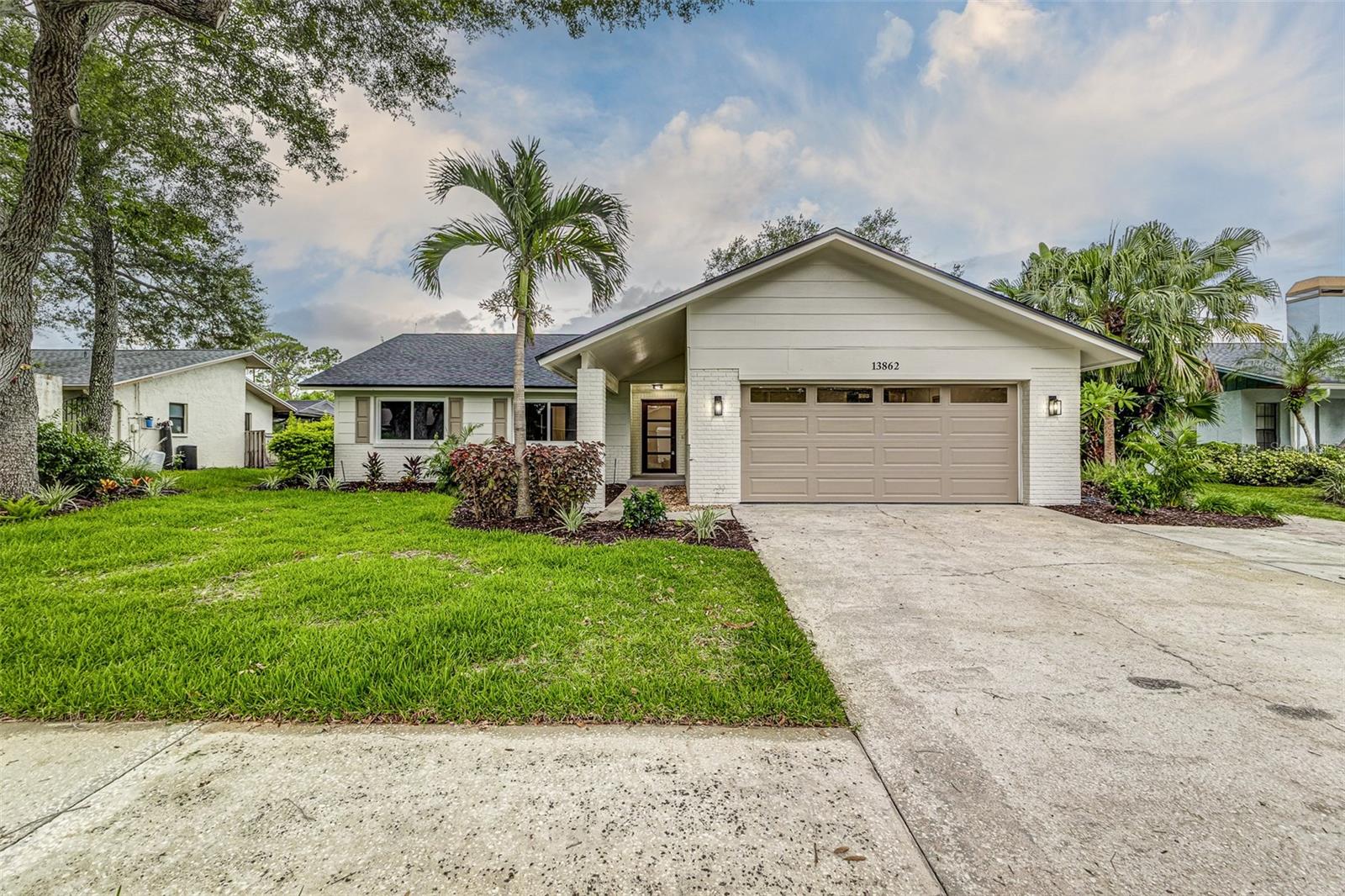Stunning, remodeled 3 bedroom/2bathroom (+DEN/Office) POOL home located in the beautiful Feather Sound community featuring vaulted ceilings and a 2-car garage. BRAND NEW wood-look TILE flooring throughout. New interior and exterior paint. This home has been fully redone with incredible upgrades from the brand-new kitchen and bathrooms to all new lights and champagne bronze fixtures throughout. The spacious kitchen boasts a stunning 10-foot waterfall island with quartz stone countertops, custom Italian-inspired cabinetry, and dual pantries, and all stainless steel-appliances including a built-in microwave. BRAND NEW Impact windows and doors provide plenty of natural light and security. The oversized slider in the living room fully collapses and opens up to a covered lanai and large pool with a screened in enclosure and landscaped backyard, perfect for indoor-outdoor entertaining. Large master bedroom features a walk-in closet and luxury style bathroom. BOTH bathrooms feature BRAND NEW limestone-look tile, floating vanities, modern lighting, retiled limestone showers and porcelain baths. A bonus flex room with closet offers versatile space for an office, pantry, or den. Every detail was tastefully chosen to create a warm, modern, and move-in ready home! Incredible location- minutes away from anything you may want or need from restaurants, shopping centers, and entertainment to schools, clinics, and easy highway access for a fast commute. The roof is just 2 years old, the HVAC is 2017, Water heater 2023. Schedule a viewing NOW!
