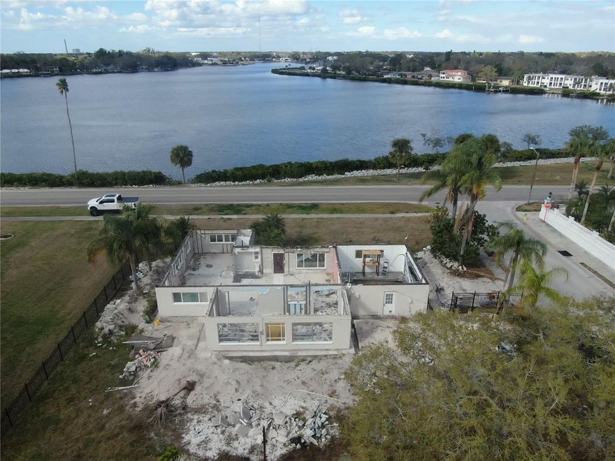 This is an opportunity for a brand new build overlooking the Tarpon Springs Bayou which has access out to the Gulf of America. The home was damaged during the hurricane and has been partially torn down to either accommodate a second story with the existing foundation and block walls or you can tear it down completely and start from new. The seller has city approved building plans that could give 2287 sq ft of living space if the buyer is interested in them otherwise a larger home can be built on the .37 acres of land it sits on. Foundation has been reinforced for a 2 story home. Dont miss this opportunity to build on this beautiful lot with water from views.