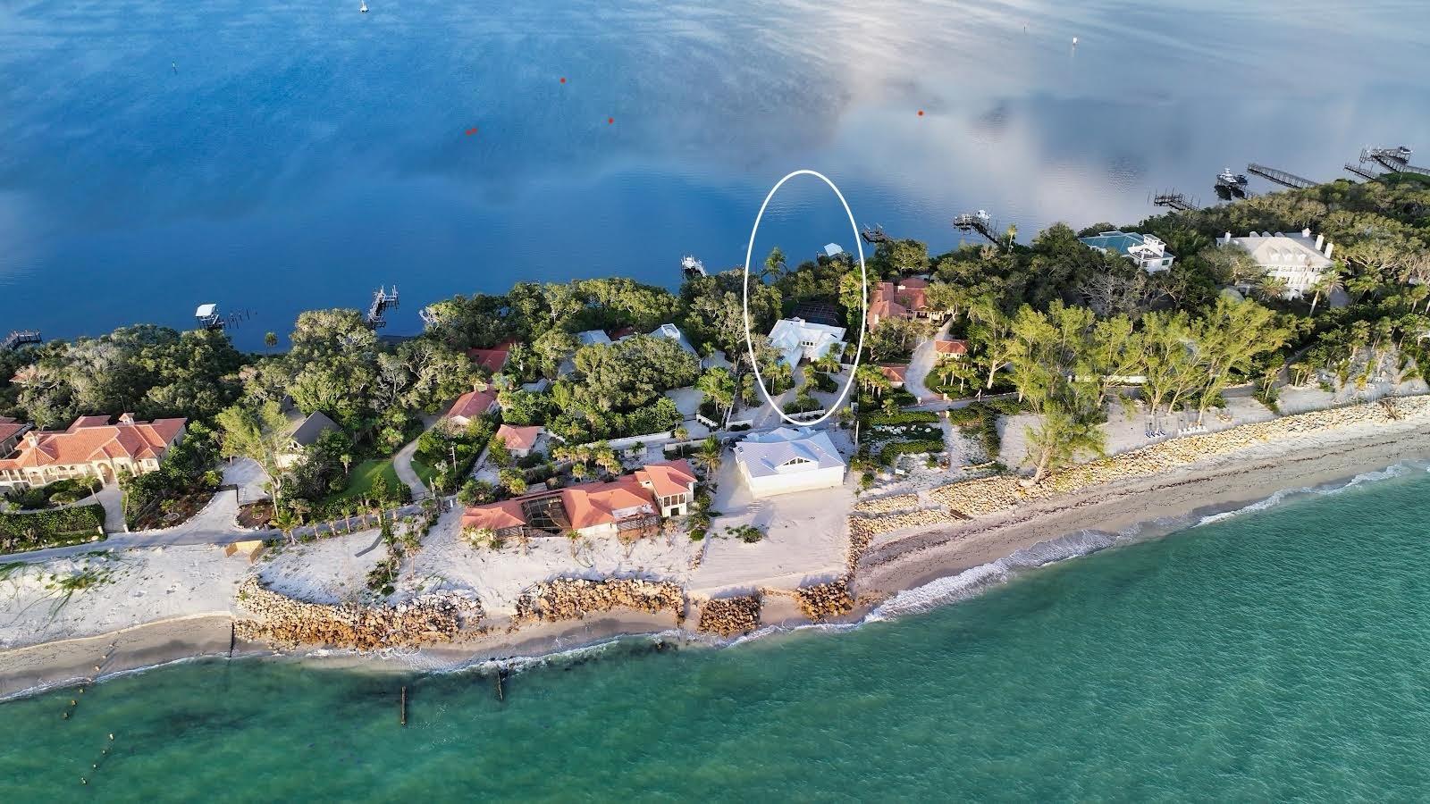 EXCEPTIONAL WATERFRONT RESIDENCE on the exclusive island of North Casey Key is a rare opportunity to own a piece of coastal Florida. Nestled in the sought-after Palmer neighborhood, this home has been lovingly maintained by the same discerning owners since 1999—a testament to the pride, care, and attention poured into every detail over the years. Set on an expansive 0.68-acre lot with 131 feet of Sarasota Bay frontage with two deeded private beach access points, the property is enveloped in lush tropical landscaping and exudes timeless Old Florida charm. The interior showcases a traditional layout with formal living and dining rooms, a spacious family room, private office, bonus room, a serene first-floor master suite, and three additional guest bedrooms. Designed for both everyday comfort and gracious entertaining, the home also features a screened-in pool and a covered boathouse accommodating vessels over 25 feet. Enjoy captivating views of the bay with breathtaking sunrises and sunsets from your own backyard oasis. Meticulously updated over time, the home includes a metal roof, 2 News AC's, PGT impact windows, a steam room, re-piping, and more—all reflecting the owners’ commitment to quality and preservation. Located just 15 miles south of downtown Sarasota and moments to Pineview (#1 Ranked School in Florida), nature parks, the Legacy Trail, this property blends unmatched privacy with access to world-class amenities. A truly special home....ready to begin its next chapter.