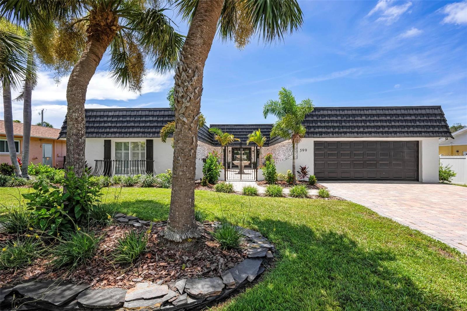 Exquisitely Reimagined Coastal Retreat – Welcome to your fully redesigned Golden Beach gem— a stunning 3-bed, 3.5-bath courtyard-style home with deeded beach access and all-new finishes. Just a stone’s throw from private sands and Venice’s historic downtown, this residence offers the ultimate blend of luxury, comfort, and thoughtful upgrades.
Step inside through the inviting front courtyard into this beautifully reimagined home. The foyer flows into an open-concept living area anchored by a decorative fireplace, luxury vinyl flooring, and hurricane-rated sliders that open to reveal a screened lanai, heated pool, and outdoor shower—perfect for seamless indoor-outdoor living.
Continuing through the home, the chef-inspired kitchen awaits, featuring two distinct sink areas, gas cooktop, abundant cabinetry, quartz countertops, generously sized island and even a dry bar complete with a beverage fridge—all ideal for entertaining. With its own slider to the lanai and a convenient in-wall gas line for grilling, outdoor recreation and entertaining are easy and enjoyable. Adjacent to the kitchen, a dedicated dining area overlooks the side yard, creating a serene backdrop for meals. Conveniently located off the dining room, you’ll find a guest powder room and easy access to the laundry room, outfitted with built-in storage for added convenience and space for all the beach towels!
The private bedroom wing begins with a luxurious master suite featuring a spacious bedroom, a marble-floored bathroom with a separate shower and elegant claw-foot tub, and a generous walk-in closet. Sliders open up into the lanai and pool area behind. Continuing down the hall, you’ll find two additional guest suites: one with a full shower and a walk-in closet, followed by another ensuite with a tub-and-shower combination and its own sizeable closet. The latter also open up through sliders into the front courtyard for an option to be outside. All three bedrooms are beautifully appointed with plantation shutters, luxury vinyl flooring, and organized closet systems.
Freshly painted inside and out and surrounded by new landscaping and rear privacy fencing, this home offers both curb appeal and seclusion. It’s equipped with updated HVAC systems, a new hot-water heater, and hurricane-rated doors and windows, ensuring comfort and security. Ideally situated just a short walk from deeded Golden Beach access—where residents enjoy private beach entry—and the historic charm of downtown Venice, this property blends coastal allure with modern luxury. This is a rare opportunity: a fully modernized beach-access home with a complete redesign, upscale finishes, and seamless indoor/outdoor living.
Whether you're searching for a cherished family beach retreat to pass down through generations, a full-time coastal sanctuary, or a savvy investment with rental income this property adapts to your dreams. You can relish peaceful family moments and tranquil sunsets with loved ones, or host vacation guests in style—the possibilities truly are endless. This is elevated living in Venice’s coveted Golden Beach neighborhood—a home to enjoy coastal elegance at its finest.