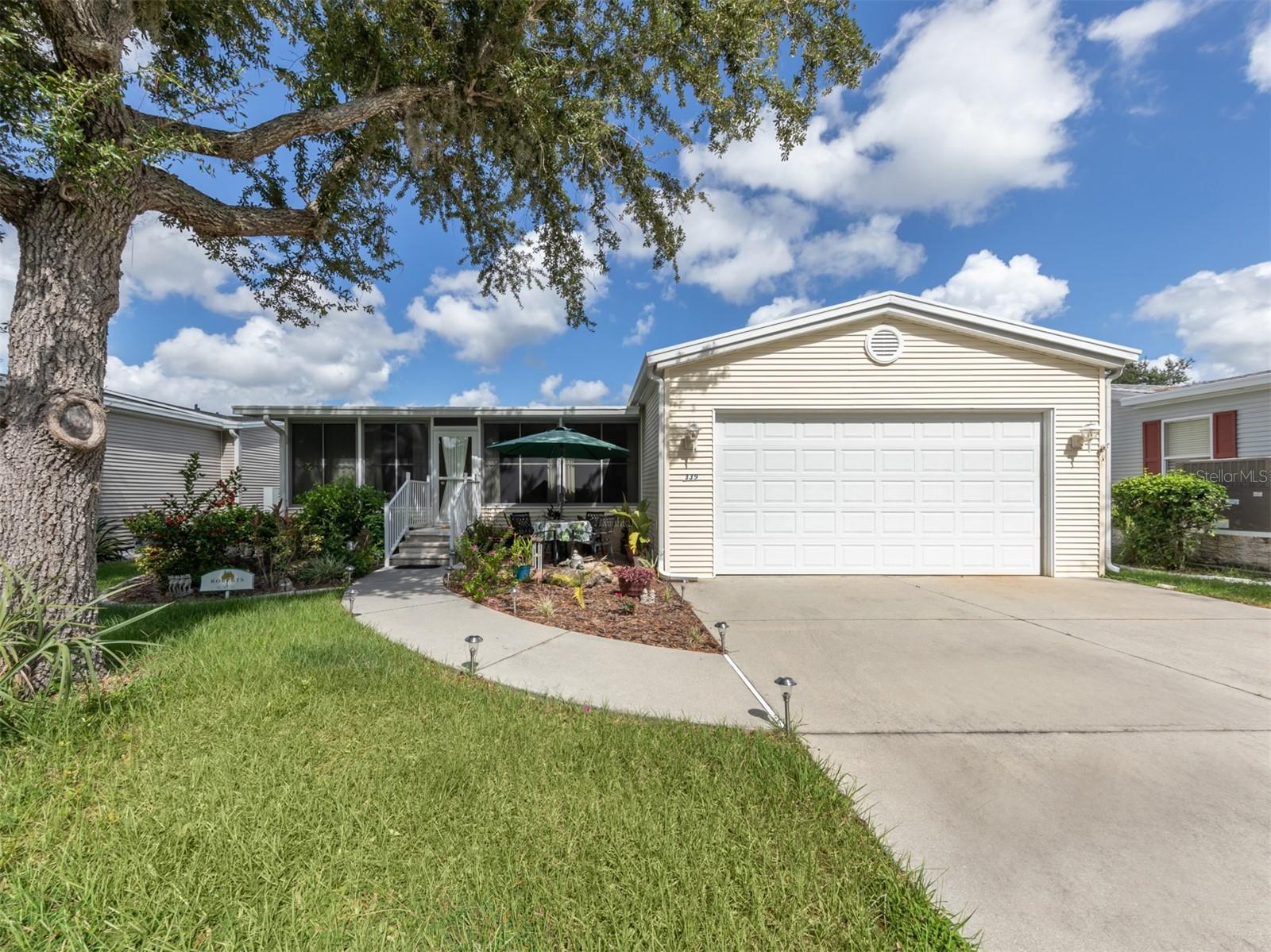 This charming 2003 Palm Harbor manufactured home is nestled along Salt Creek in the Village at Riverwalk, offering tranquil views of the preserve across the street. Featuring 3 bedrooms, beautiful bamboo floors in the living areas and bedrooms, and a spacious island kitchen, the open floor plan creates an inviting atmosphere. Recent updates include a 2023 roof, brand-new AC, and brand new windows throughout. The ensuite master bath boasts double sinks, a walk-in shower, and a large walk-in closet. Inside laundry, a two-car garage, golf cart and turnkey furnishings add to the convenience of this lovely home. The front Florida room, enclosed with acrylic windows, provides comfortable year-round use, while a charming paver patio in the front yard offers a perfect spot to relax. Located in the desirable Village at Riverwalk, residents enjoy access to scenic walking trails, a kayak launch, and lush, mature landscaping, all situated along the beautiful Myakka River in North Port, Florida.