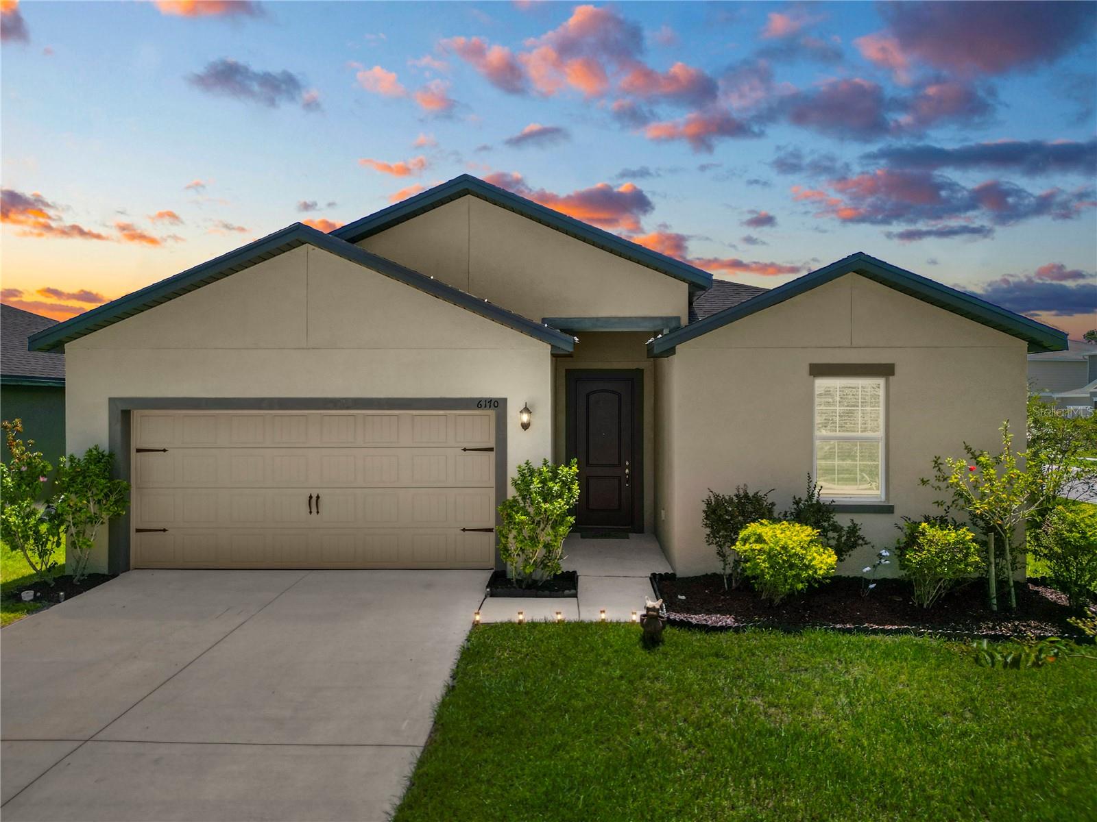 Welcome home to this stunning five bedroom, three bath home, built in 2021. Step inside to find a modern and open floor plan with plenty of natural light flowing throughout. The kitchen boasts stainless steel appliances, granite countertops, and a large island, perfect for meal prep or entertaining guests. The master suite is a true retreat with a walk-in closet and en-suite bathroom featuring dual vanity. This home also features an inside laundry room for added convenience. This community offers amenities such as a pool, playground, and walking trails, making it a perfect place to call home.This spacious home features a covered patio, fully fenced yard, perfect for pets or children to play in safely. The two car garage provides ample space for parking or storage. Conveniently located near shopping, dining, and entertainment options, this home offers the ideal combination of comfort and convenience. Close access to I-4 offers a convenient commute to Tampa or Orlando!