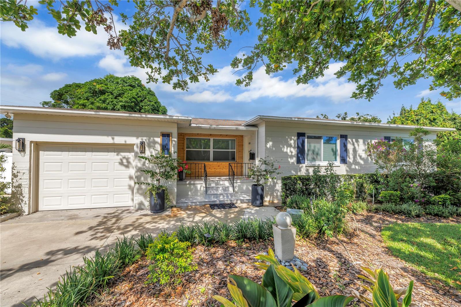 Welcome to this immaculate 2-bedroom, 2.5-bathroom block home with a 1-car garage, perfectly situated on a spacious corner lot in the heart of Disston Heights. Offering 1,105 sq. ft. of updated living space, this property offers peace of mind living, with gorgeous finishes. The open-concept modern kitchen and living room flow beautifully into a versatile dining or flex space. The bedrooms have great natural light and beautiful wood flooring throughout. Outside, the fully fenced backyard offers privacy and space for outdoor living and entertaining. A tasteful paver patio, large locking storage shed, and four-zone sprinkler system with well and pump add both functionality and charm. Landscape lighting on three separate zones provides a warm, inviting glow as soon as the sun sets, with automatic LED illumination based on outdoor light levels. The property also includes a separate structure in the backyard, ideal for use as a home office, workout space, media room, or guest suite. This additional space is fully equipped with electric, water, a mini-split AC/heat unit - offering both comfort and convenience. Located just steps from Sirmons Lake Park, you’ll enjoy easy access to walking paths, picnicking, and fishing, as well as being on some of the highest ground in St. Petersburg.