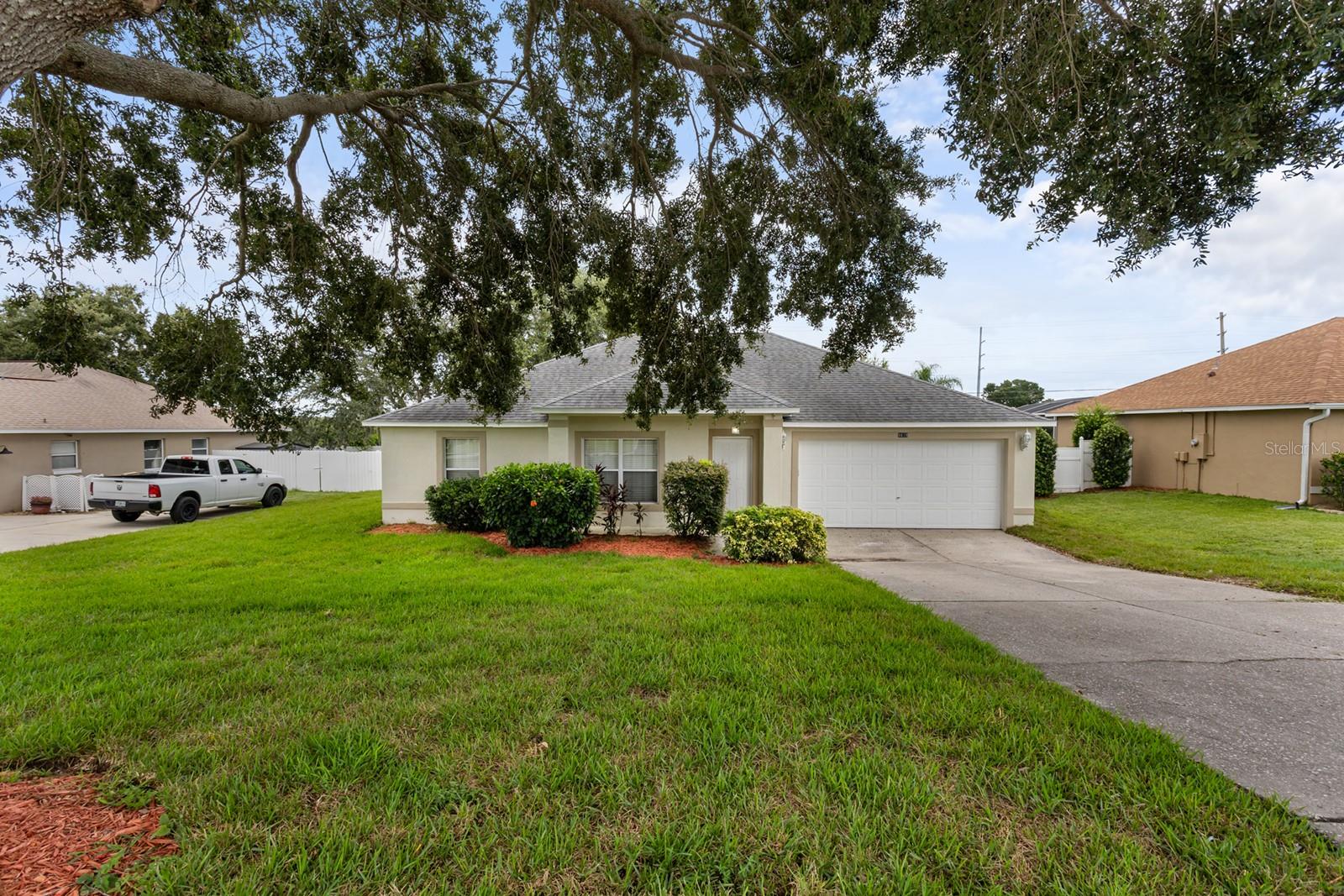 Welcome to this beautifully maintained 3-bedroom, 2-bath home offering 1,540 square feet of comfortable living in the sought-after Louisa Pointe community. With excellent curb appeal, a 2017 roof, 2018 AC, and upgraded modern lighting throughout, this home is sure to impress. Inside, a spacious eat-in kitchen awaits, featuring abundant cabinetry, a pantry, generous counter space, and a breakfast bar that seamlessly opens to the living room. Soaring cathedral ceilings fill the space with natural light, while sliding glass doors lead to a covered patio overlooking the large, fenced backyard—ideal for outdoor entertaining with plenty of room for a future pool. The private master suite includes a walk-in closet and en-suite bath with dual vanities and a walk-in shower. Two additional bedrooms and a full guest bath are thoughtfully positioned on the opposite side of the home for added privacy. Perfectly located near the Clermont Chain of Lakes and Lake Louisa State Park, you’ll enjoy easy access to outdoor recreation, trails, and the lake. Convenient to Highway 27, Disney, downtown Clermont’s farmers market, festivals, shopping, dining, medical facilities, and golf. Don’t miss the opportunity to make this wonderful home yours—schedule your private showing today!