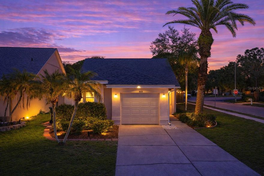 A well-maintained corner lot, a screened side entry surrounded by tropical landscaping, and thoughtful updates throughout highlight this 3 bedroom, 2 bath, 1 car garage home in the established Tampa community of Countryway. The entry offers a warm, private welcome, opening into an expansive living/dining room with vaulted ceilings, transom windows, and a natural flow that feels open without losing a sense of structure. Light moves easily through the main living areas, where luxury vinyl plank flooring carries throughout and a statement fireplace with fluted wall detailing anchors the space with a clean, architectural aesthetic. Sliding glass doors extend the layout into the enclosed sunroom, while a pass-through breakfast bar with upper cabinetry creates a subtle connection to the kitchen, giving you that open feel while still maintaining separation. This well appointed kitchen offers granite countertops, stainless steel appliances, pantry storage, and that functional pass-through makes serving and entertaining into living area a breeze. There is also room to incorporate a dinette, allowing flexibility depending on how the space is used day to day. Positioned separately from the secondary bedrooms, the primary suite offers direct access to the sunroom, a walk-in closet, and an updated ensuite with a modern, cohesive style. Dual sinks with stone countertops, a glass-enclosed walk-in shower, and updated lighting and mirrors give the ensuite a clean, finished feel. On the opposite side of the home, two additional bedrooms provide comfortable accommodations for guests or family, along with a full bathroom that carries through the same updated style. An interior laundry room and attached garage add everyday functionality, while the enclosed sunroom creates an additional area to relax, unwind, or gather. Outside, the fully fenced yard takes full advantage of the corner lot, offering room to spread out, entertain, or simply enjoy the surroundings. Countryway residents have access to a variety of recreational amenities including basketball, tennis, volleyball, soccer, and baseball courts, along with two dog parks and a playground. Optional memberships are also available at the Countryway Golf Club. Do not miss your opportunity to view this home in an excellent location. Call us today for your private tour!