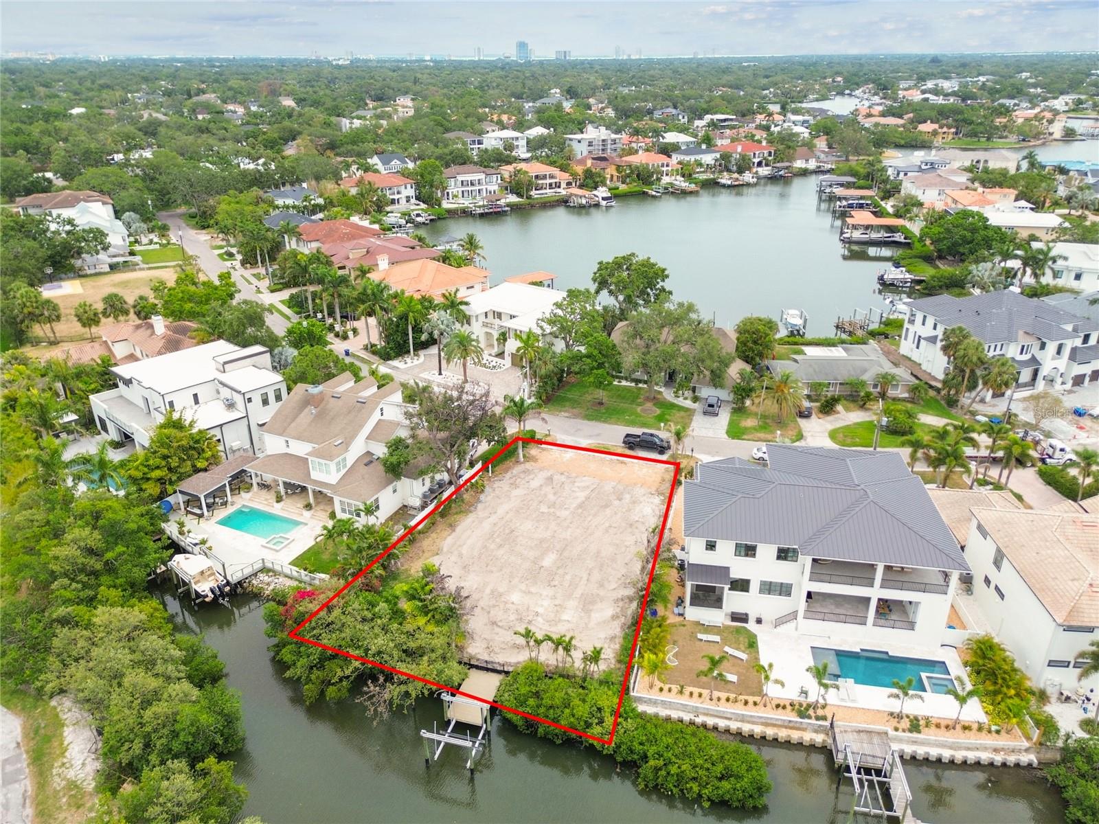 Waterfront living at its finest. Unlock the potential of this exceptional vacant residential lot with open access to Tampa Bay. Perfectly situated on a picturesque canal in one of South Tampa's most desirable neighborhoods and streets. Water access at your fingertips from your private Dock with 20K Capacity Boat lift. This property offers an incredible opportunity to build your dream home in a serene setting while enjoying the vibrant lifestyle that South Tampa has to offer. Surrounded by mansions, Spanish Main Street is a highly desirable location. No HOA or CDD fees. This prime site combines luxury living with convenience, as you’re just minutes away from Tampa International Airport, the Westshore Business District, International Plaza, Raymond James Stadium, I 275, Veteran’s Expressway, and thousands of shopping, dining, and entertainment options. Whether you’re looking to create a private oasis or as an investment property, this lot provides the ideal canvas for your vision. Seize this rare opportunity to create your own coastal retreat on beautiful Tampa Bay!