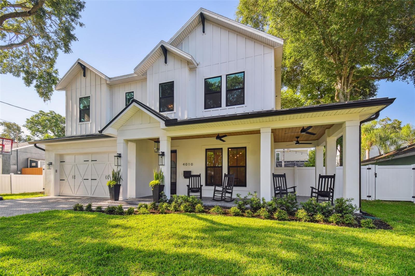 A custom modern farmhouse awaits built by Vintage Builders in 2021. Located in the heart of the highly desirable Virginia Park in South Tampa, this home welcomes you with a large wrap around front porch, wood planked ceilings, and 10 ft ceilings. As you enter the home, the spacious office is to the right with custom barn doors. The floor plan opens out to a formal dining, great room, and oversized eat in kitchen. From the kitchen and family room—large slider doors and windows look out on travertine paved lanai and large swimming pool with ample room for outdoor entertaining and play, all privately and securely surrounded with white vinyl fencing.
The home offers a lot of natural light and a timeless beauty while providing a functional layout, perfect for entertaining. The formal dining space could be used as an extended formal living space.
The 2 car garage, half bath, and organizational alcove space provides functionality and tons of storage.
Custom staircase leads to open large secondary living space. A large master bedroom features coffered 12’ ceilings, a walk-in closet, master bathroom with two separate vanities, large shower with glass enclosure and separate free-standing bathtub. 2 bedrooms share a jack and jill bathroom, and the 4th bedroom has a private bath. There is also a spacious laundry room with soak sink and storage.
Additional features: Impact windows, tankless water heater, 10" ceilings throughout, hardwood floors, natural gas 5 burner cooktop, quartz countertops, custom walk-in pantry, crown molding, and 3 way sliding glass door to backyard.
Walking distance to Friendship Park, shopping, and dining.