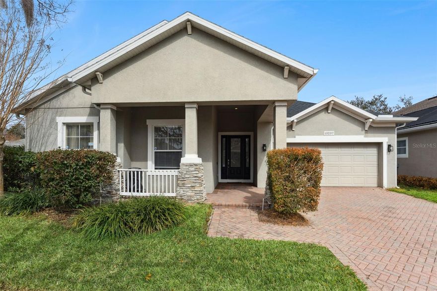 Searching for a single story, 4-bed home in Windermere near Walt Disney World with space, convenience, and long term value? 13237 Fossick Rd offers 4 bedrooms, 2 full baths, 2,516 square feet of living space, a NEW ROOF from 2022, and a 0.21 acre corner lot in the Providence community, minutes from Disney, Winter Garden Village, and major commuter routes. The concrete block and stucco construction provides durability and classic, easy to maintain Florida curb appeal. From the moment you arrive, the covered front porch with column detail, stone accents, and paver driveway creates a warm first impression. Inside, a light filled formal living room off the foyer offers flexibility as a sitting room, home office, or quiet retreat separate from the main living areas. The kitchen is centrally positioned and overlooks the informal dining space and spacious family room, creating seamless flow for daily living and entertaining. Granite countertops, stainless steel appliances, abundant cabinetry, breakfast bar seating, and a center island provide both function and gathering space. Open sight lines keep everyone connected. The primary suite is generously sized with room for a seating area and direct access to the screened lanai. The ensuite bath features dual vanities, a soaking tub, separate glass shower, and walk in closet. Three additional bedrooms offer ideal flexibility for guests, remote work, or multigenerational living. Step outside to a covered screened lanai that extends your living space year round. The backyard offers green space and mature trees, creating privacy and room to relax after a day exploring Orlando’s attractions. The single level design appeals to buyers seeking long term convenience without stairs. The Providence neighborhood is perfectly located and is zoned for Windermere Elementary, Bridgewater Middle and Windermere High. If you are looking for space, location, and long-term upside in Windermere, this home deserves a closer look. Schedule your private tour today!