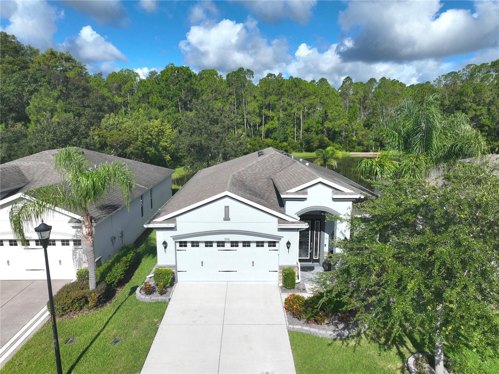 Move-in Ready 3 Bedroom, 2 Bath Home with Serene Pond Views! Built in 2017, this beautifully maintained home offers a split-bedroom floorplan and a peaceful backdrop of pond and conservation views. The kitchen features elegant cabinetry, granite countertops, tiled backsplash, and sleek black stainless steel appliances - New Refrigerator, Microwave, and Dishwasher. Tile flooring runs throughout the main living areas, while both guest bedrooms have been upgraded with new laminate flooring. The primary suite includes grab bars for added safety, an updated ceiling fan, re-tiled shower floor, and modernized faucets. Additional upgrades include resealed grout throughout the home, new patio doors, and a recently replaced A/C capacitor (2024). The exterior was freshly painted and fitted with new gutters in 2024, garage floor has an acrylic finish, and the water softener was recently rebedded. Enjoy upscale yet simple landscaping and the convenience of HOA-covered services including cable, internet, lawn care, and access to incredible amenities: swimming pools, fitness center, pickleball and tennis courts. This vibrant community also features a golf course, restaurant, and pub—everything you need for an active and social lifestyle. Furniture and Golf Cart also available for sale outside of the purchase contract. Come view this home today!!