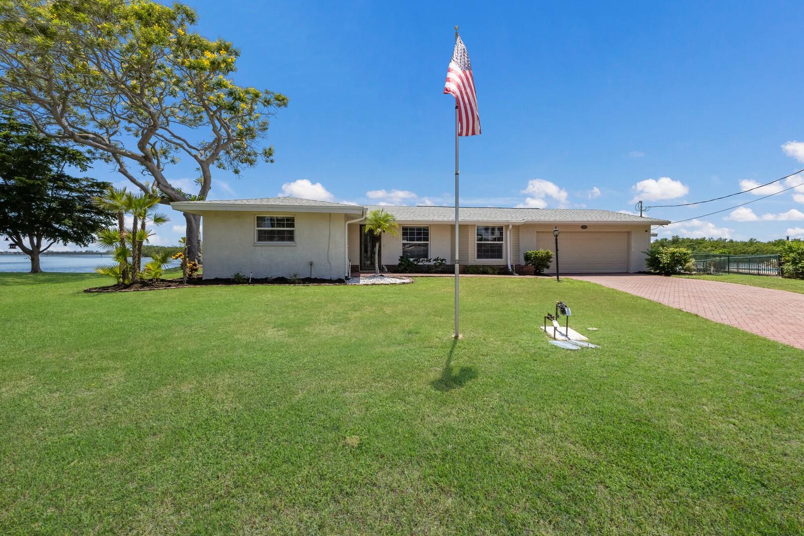 One or more photo(s) has been virtually staged. LOCATION LOCATION LOCATION!!! Bay Front Pool Home in Flamingo Cay!! Perfectly positioned on one of the most sought after open water corner lots in Flamingo Cay, this exceptional three bedroom, three bathroom waterfront home offers a rare combination of privacy, panoramic views, and the ultimate Florida lifestyle. Set against the tranquil beauty of the bay, the property delivers an ever-changing backdrop of vibrant sunsets, sparkling water, and gentle breezes that can be enjoyed from nearly every room, creating a daily sense of vacation. Thoughtfully designed with a split-bedroom layout, the home offers both comfort and privacy. The spacious primary suite is tucked away on one side of the house, providing a peaceful retreat with its own water views, generous closet space, and direct access to the outdoor living areas. Two additional bedrooms and baths are located on the opposite side of the home, ideal for family members or visiting guests. This separation of spaces allows everyone to enjoy both quiet privacy and comfortable gathering areas. The flowing floor plan is open yet well-defined, with multiple living and dining areas that capture the waterfront setting through walls of windows. A wood-burning fireplace adds warmth and character, making the home feel just as inviting on cool Florida winter evenings as it does on sunny summer afternoons. The updated galley-style kitchen features crisp white cabinetry, granite countertops, modern hardware, and abundant storage, offering both beauty and functionality. Its efficient layout makes meal preparation effortless while still keeping you connected to family and friends in the surrounding living spaces. Just beyond, a screened-in porch invites you to linger over morning coffee, savor an evening cocktail, or simply watch dolphins, manatees, and seabirds pass by. Outdoors, the property is a true waterfront paradise. A sparkling pool sits center stage, bordered by lush green lawn and sweeping water views. The private dock extends your living space onto the bay, where you can fish, launch a kayak or paddleboard, or set off by boat to explore the area’s stunning waterways. The home’s rare corner-lot position means expansive sightlines and added privacy from neighboring properties, making it ideal for both quiet relaxation and hosting guests. This home also offers peace of mind — it has withstood Florida’s seasonal storms without water intrusion into the house during last year’s hurricanes! Flamingo Cay’s prime location means you are just minutes from the white-sand beaches of Anna Maria Island, along with world-class dining, boutique shopping, championship golf, and the vibrant arts and culture of Bradenton and Sarasota. Whether you are seeking a year-round residence or a luxurious vacation retreat, this property delivers an unparalleled blend of elegance, comfort, and the very best of Florida waterfront living.