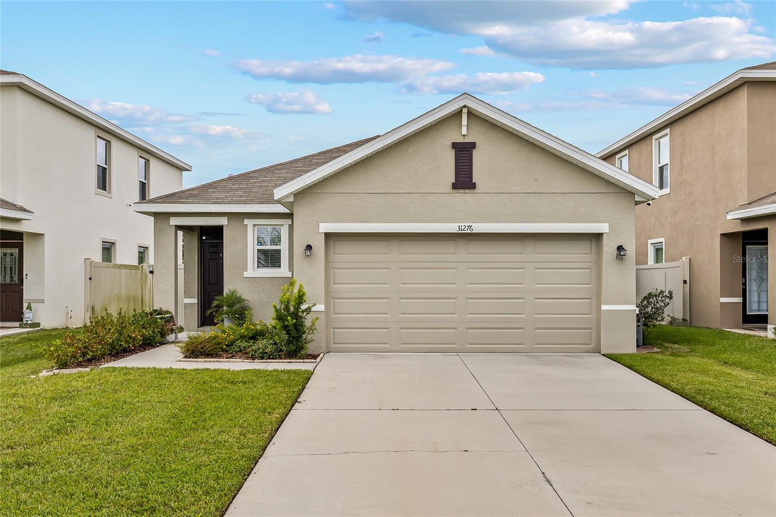 Beautiful completely fenced in home in the sought-after Epperson Lagoon community. Home features 3 Bedrooms / 2 Bathrooms, master bath recently updated. Light kitchen cabinets, stunning backsplash and stainless steel appliances, washer & dryer included. Extended patio – perfect for outdoor living and gardening. Inside has open-concept layout with natural light. Move-in ready condition. Community Amenities include 7.5-acre Crystal Lagoon with sandy beaches & water activities. Walking, biking and golf cart trails. Dog parks, playgrounds and butterfly garden. Eagle Park & Lake House for gatherings and fitness. Easy access to I-75, I-275, and major roadways, Close to Tampa Premium Outlets and Shops at Wiregrass. Minutes to dining, entertainment and medical facilities. Highly rated Pasco County schools (Watergrass Elementary, Thomas E. Weightman Middle, Wesley Chapel High). Short drive to Downtown Tampa, Tampa International Airport, and Gulf Coast beaches? This home combines modern comfort, unbeatable community amenities, and a prime location — the perfect choice for your next move! Not only a community but a lifestyle.