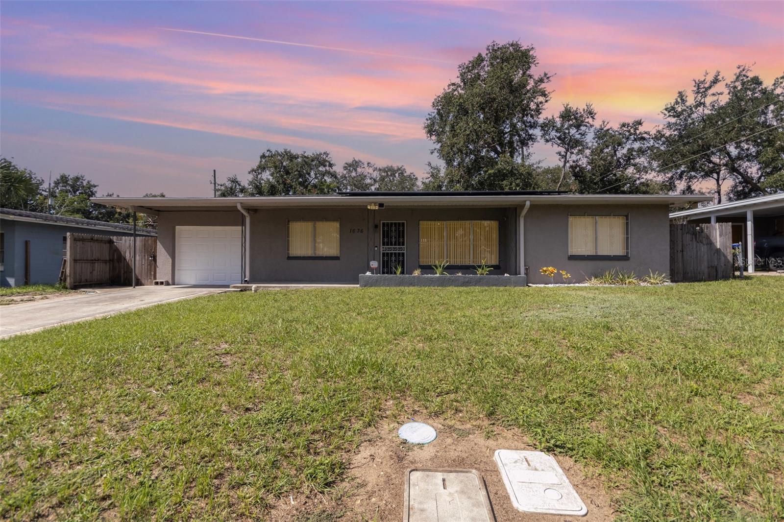 Peace of mind comes with a 2025 roof plus an A/C and water heater that are approx. 5 years old. Energy bills stay low thanks to solar panels, which the seller will pay off at closing—averaging around $100 even in the hottest months. Inside, classic terrazzo floors bring timeless style and easy care. The large, fenced backyard offers plenty of room to relax, garden, or play. With all the big-ticket items already updated, all that’s left is to make cosmetic upgrades on your own time and your own terms. This home blends comfort, efficiency, and value—ready for its next owner to love. Enjoy your new, charming, 3-bed, 2-bath, 1-car garage home with 1,320 sq ft of living space close to major roadways for travel and shopping, dining and more!