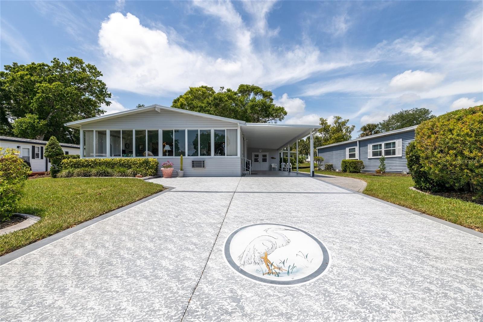 This spacious, remodeled, and fully furnished 2-bedroom home is filled with natural light and offers 180-degree views from the expansive multi-purpose living room and entryway. Enjoy a cozy eat-in kitchen, fully equipped with modern appliances, along with a separate built-in bar and workspace. Relax in the evenings in the comfortable family room, or spread out for a game of cards with friends. The extra-wide hallway leading to the bedrooms offers ample storage, a separate laundry room, and a quiet master bedroom tucked away at the back of the home. The carport accommodates two vehicles, with additional space for a golf cart, lawn equipment, and more in the large enclosed shed. This home is truly turn-key and ready for its new owners. Edgewater Landing is an active 55+ community located on the Intracoastal Waterway (ICW), featuring countless amenities—including a private boat yard, boat launch, and observation deck where you can enjoy views of wildlife, rocket launches from the Space Coast, and dolphins in the river. Schedule your showing and community tour today!