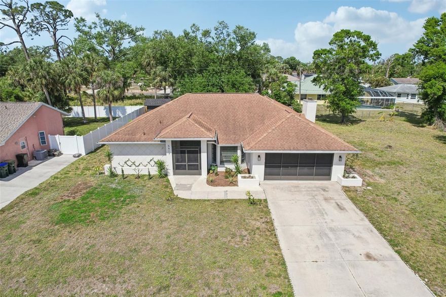 Welcome to your dream home! This beautiful and FULLY updated, well maintained 3-bedroom, 2-bathroom property on CITY WATER on a DOUBLE LOT! Endless potential with a double lot in the heart of North Port already cleared and ready for a garden, detached garage, and more! This property offers the perfect blend of comfort and style. This home boasts a spacious open floor plan, ideal for both relaxation and entertaining. With TWO living spaces including a wood burning fireplace along with custom built-in shelving. The bright and airy living area flows seamlessly into a modern kitchen featuring stainless steel appliances, ample cabinetry, and spacious double waterfall island over looking the backyard. The master suite provides a private oasis with a walk-in closet and an en-suite bathroom complete with a dual vanity and a walk-in shower. Two additional bedrooms offer plenty of space for family, guests, or a home office. Step outside to a serene backyard, perfect for gatherings or unwinding after a long day. Newer roof put on in 2020. This home is conveniently located in a desirable neighborhood off Salford located near CocoPlum Shopping plaza, great schools, parks, shopping and more! Come look at this stunning move-in ready property waiting for you to make it your own! Don’t miss out on this incredible opportunity—schedule your showing today! Offering price now includes the parcel to the right of home.