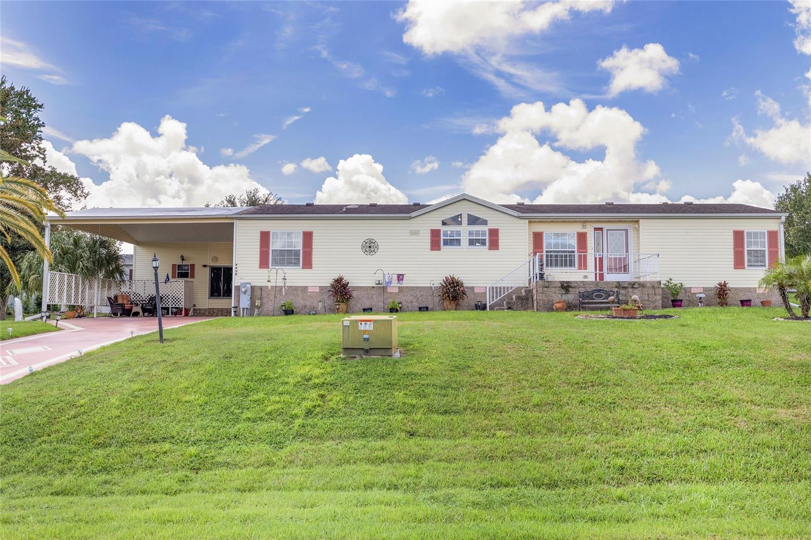 Location, Location, Location!! – This AMAZING 2,573 Sq Ft Home with 4 Bedrooms, 2.5 Baths, and Expanded Carport 24’x27’ that can accommodate 4 CARS is just outside of The Villages, FL in Hilltop Estates, close to the VA Clinic on Route 42 in Summerfield!! – Fantastic 55+ HOA Neighborhood with a Clubhouse that has a Full-Kitchen that you can RESERVE FOR PRIVATE PARTIES, Swimming Pool & Spa, Pickleball Courts, Shuffleboard Courts, and other Amenities! The HOA covers a NEIGHBORHOOD PRIVATE WELL & Sewer System, HOA Maintains the Common Areas and Includes Weekly Trash p/u – 2015 Roof & 2021 HVAC!! -- Freshly painted Interior with New Ceiling Fans and Light Fixtures! – No Carpet, only Laminate & Tile Flooring in this Home! Lots of Windows & Eyebrow Arched Windows for Natural Light!! - The Custom Painted Driveway greets you with Rubber mulch in the Landscape Beds, Gutters & Downspouts and Front Porch with Railing –-- Large Entry Foyer and Living Room with Vaulted Ceiling and Cozy Wood-Burning Fireplace with Tile Surround and Mantle – You will fall in Love with the Kitchen! It has 2020 Stainless Appliances, Dual-Height Center-Island with Base Cabinets & Breakfast Bar, Cabinets with Custom Pulls & Crown Molding, Eating Space, Kitchen Buffet/Bar with Bar Sink & Overhang, Pantry Cabinets, Laminate Countertop with Tile Backsplash, Stainless Steel Sink with Built-in GLASS WASHER, Upgraded Gooseneck Faucet with Internal Sprayer, Windows with Transom Windows to Front Yard – Primary En Suite Bedroom with Walk-in Closet and a BEAUTIFUL BATHROOM with Dual Sinks, Built-in Linen Closet, REMODELED STEP-IN SHOWER with Solid Surface Walls & Floor Pan & Glass Surround with Glass Swing Door, Corner Bench Seating, Built-in Shampoo Niche, Multi-sprayers (One is Handheld) – Guest Wing with 2 Bedrooms and Hall Bath – Bedroom 4 has its own Half Bath and PTAC HEATING & COOLING UNIT!! - Separate Dining Room, and Laundry giving access to lower level with Office & BONUS ROOM! – An AMAZING STORAGE ROOM with Workbench & Storage Cabinets!! – This Home has it All!! – UNIQUE AND TASTEFULLY UPGRADED giving many options for Entertaining and Living!! – Don’t miss out on this ONE-OF-A-KIND Gem in a Fantastic Location!!
