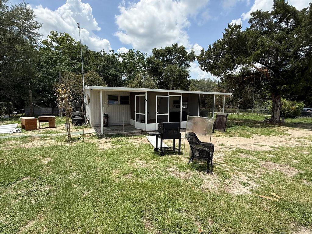 Photo of 10360 SE 131st Lane, Ocklawaha, FL 32179 (MLS # OM725829)