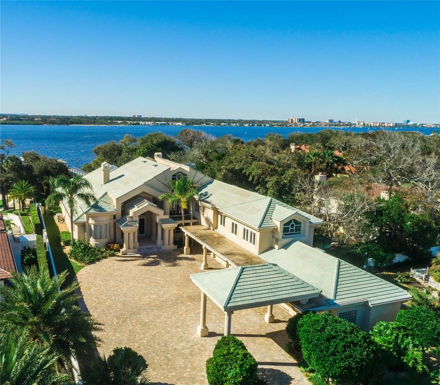 Get ready to be swept off your feet! This breathtaking estate, sprawling over 1.5 acres, is an oasis of elegance and tranquility, offering 107 feet of prime Intracoastal waterfront. Designed for idyllic living, this masterpiece boasts extraordinary views that you have to see to believe! Imagine hosting unforgettable gatherings in your spectacular outdoor living space where sunshine and stunning vistas await, or savoring exquisite wines from your custom wine cellar that holds over 500 bottles under stunning coffered ceilings. With a wet bar, home gym, and a lavish spa room complete with a sauna, every day feels like a luxurious getaway! This gated estate ensures your privacy behind a concrete wall and features an expansive paver motor court leading to a colossal entrance and a 6-car garage. With over 10,000 sq ft of thoughtfully designed living space, you'll find 6 spacious bedrooms, an office, and 7 elegant baths. The riverfront family room, adorned with oak wood flooring and a stunning travertine stone fireplace, is just the beginning. The gourmet kitchen, featuring hand picked oak flooring and a custom island, opens up to a cozy eat-in area that overlooks the sparkling water. Retreat to your luxurious downstairs owners suite with a charming sitting area and an opulent primary bath dressed in marble. But wait, there's more! Your resort-style backyard includes a heated pool, a grand travertine pool deck, a summer kitchen, and a Tiki bar perfect for entertaining. Plus, with a deep-water dock that comes with a 10,000 lb boat lift and 5,000 lb jet ski lift, adventure awaits just minutes from the inlet and a couple of blocks from the ocean. Don't miss your chance to own this slice of paradise. Schedule your private showing today. Your dream lifestyle is just a call away!