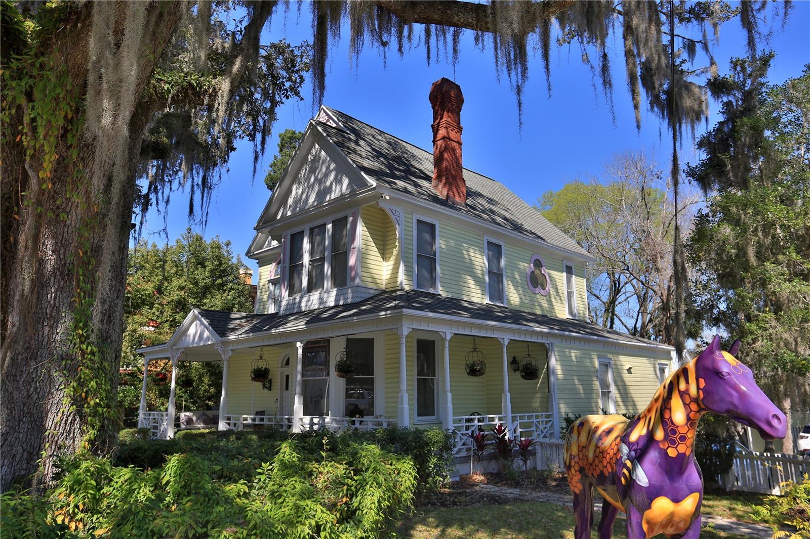 Discover the charm and elegance of this stunning Victorian property on .42+/-acres, built in 1891. It boasts exquisite stained-glass details and is located on a prime double lot with generous road frontage on E. Fort King and Wenona Avenue. This income-producing gem offers a wealth of possibilities for both personal enjoyment and investment potential!
Enjoy a spacious and inviting layout that seamlessly connects the recently updated kitchen, living room, and dining area, creating an ideal space for entertaining and daily living.
Second Floor (897 +/- SF): Retreat to the owner’s suite, which features a cozy fireplace, a comfortable sitting area, a full bath, and a kitchen. Step outside to your screen-enclosed patio, perfect for relaxation and unwinding.
Third Floor (378 +/- SF): This level offers a private bedroom, bathroom, and full kitchen ideal for guests or as additional living space. A detached garage is currently used as an air-conditioned office space, providing versatile options for work or hobby use.
A separate 2-story duplex: The first floor is a charming 400 sq. ft. studio apartment with a one-car garage. The second story features a spacious 2-bedroom, 1-bath unit that features 600 sq. ft. of living space, complemented by a delightful patio and screen porch. Both units are equipped with new appliances and have recently updated roofs. Ample paved parking is available for up to 5 vehicles.
RBH3 zoning allows for diverse uses, making it suitable for family residences, two-family dwellings, boutique shops, art galleries, professional offices, and much more.
This captivating property beautifully blends historic charm with modern amenities, offering endless potential for the right buyer. Don’t miss out on the chance to make it yours! Schedule a viewing today and unlock the possibilities that await.