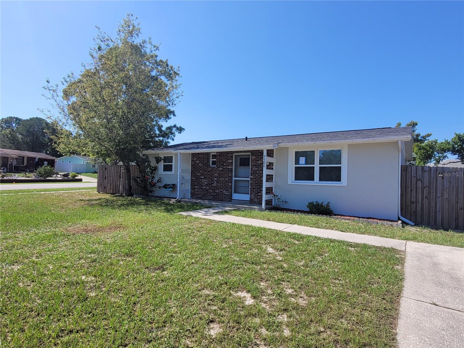 Affordable and move-in ready home located on an oversized corner lot in a quiet Spring Hill neighborhood! This home just had a new roof installed (Summer 2025)! Also recently installed, the home has beautiful 12x24 tile plank flooring throughout for easy maintenance! Enter through the front door into a spacious living room. The dining area is located adjacent to the kitchen and there is a equally spacious family room that could serve many purposes. The kitchen has a newer cabinets, new refrigerator (2025) and a practical pass-through over the sink to the family room making it easy to communicate with everyone. Next to the kitchen you will find a laundry room with access to the large backyard that is fully enclosed with a privacy fence complete with two gates for easy access. A sizable garden shed provides extra storage. Other features: newer Maytag Heatpump system plus additional mini split unit in the family room, newer water heater (2019), privacy fence (2022). This home is centrally located with easy access to shopping, dining, medical services and hospitals, and major roadways including Suncoast Parkway just minutes away for easy commute to Tampa and international airport. Nearby, enjoy the many local attractions including Weeki Wachee State Park with its world famous Mermaids, Pine Island beach area, fishing piers, numerous boat ramps and kayak launch areas or take a short drive to Homosassa Springs State Park or visit Brooksville for many other activities and festivals throughout the year.