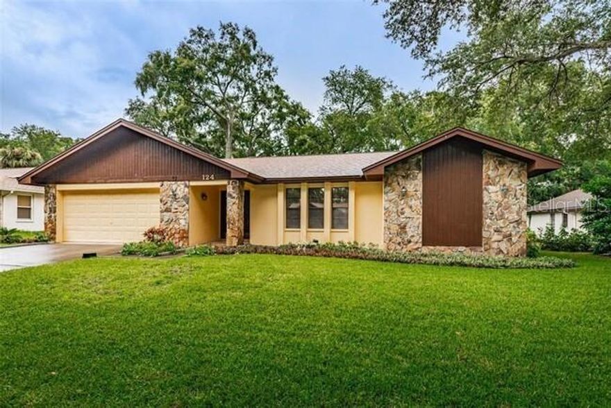 Updated home featuring ~ stone counters ~ updated white cabinets ~ beautiful wood floors throughout ~ two car garage and lots of living space..... PLUS Lawn Service is included!  You'll find plenty of room in this home:  large living room, separate dining area, kitchen with lots of counters & cabinets, pantry cabinets, stone surfaces & all appliances.  The kitchen is open to the family room for family time and gathering. Split bedroom plan with primary bedroom featuring an ensuite bath and walk-in closet.  Two other bedrooms and large bathroom located off the family room, and separate laundry room  includes the washer, dryer & utility sink.  Oversized back screened patio extends your living space.  The large back yard is surrounded with a partial fence and trees. The neighborhood is quiet BUT located just off Tampa Rd and near US-19, retail, shopping and beaches.  Home is offered with the existing furniture, or furniture will be removed...AND Lawn care is Included!