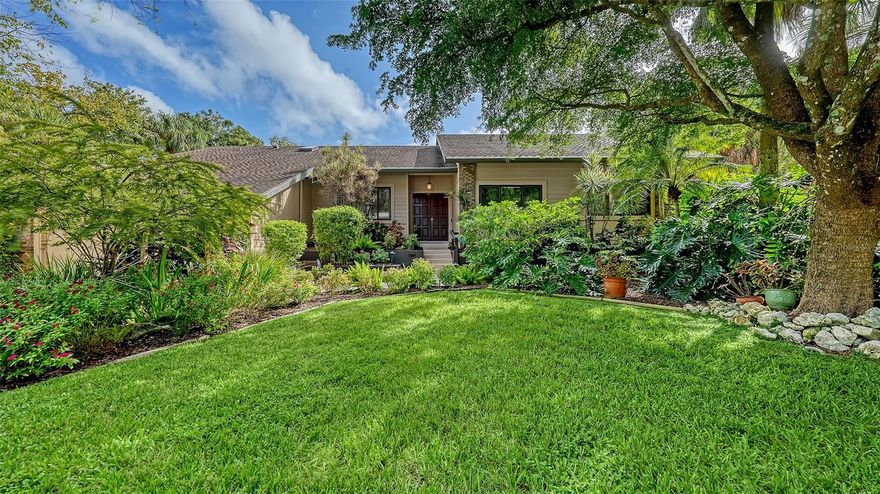 Set on an elevated and oversized lot gracefully shaded by mature oak trees, this inviting 5-bedroom plus office, 3.5-bath pool home exudes warmth, timeless appeal, and evident pride of ownership, with every detail reflecting thoughtful care and attention. Offering nearly 3,000 square feet of comfortable living space, this impeccably maintained residence welcomes you with a charming double-door entry that opens to bright, airy interiors filled with natural light and a sense of openness enhanced by soaring ceilings and a smart, split-bedroom floor plan. The home’s interior design balances comfort and practicality, featuring engineered hardwood floors in all bedrooms, fresh interior paint, and custom built-ins that add both character and function. The spacious living area with Eurotech custom built-in provides plenty of room for gatherings, while the large kitchen offers stone countertops, Eurotech high gloss enamel cabinetry, a breakfast nook overlooking the pool and easy flow to the dining room and main living spaces—ideal for family life or entertaining. An office with handsome built-in offers a quiet place to work or study. The primary suite serves as a peaceful retreat with 2023 engineered hardwood floors, spacious walk-in closet and a beautifully renovated 2023 primary bath featuring a glass-enclosed shower, freestanding soaking tub, quartzite-topped double vanity, skylight and designer porcelain tile—bright, fresh, and spa-like. The guest bedrooms are all generously sized, with large closets and excellent natural light. One of the full baths conveniently doubles as a pool bath for easy access from the outdoor areas. Practical features add peace of mind and long-term value, including 2 HVAC systems, Ring doorbell camera, whole house water softener, kitchen reverse osmosis system, 2023 exterior paint, and a full-floor garage attic for exceptional storage. The laundry room is both functional and attractive with ample cabinetry and a utility sink. Outdoors, the private pool area is surrounded by lush tropical landscaping, creating a peaceful backdrop for relaxing, exercising, or dining al fresco. Multiple screened-in areas provide flexible space for outdoor enjoyment year-round including a greenhouse or separate play/exercise area. Located in the sought-after community of The Lakes Estates, residents enjoy two heated pools and spas, Har-Tru tennis courts, a playground, half-court basketball, fitness center, scenic walking paths, and a lakeside fishing pier. Just minutes from excellent schools, shopping, dining, and Sarasota’s world-famous beaches, this home offers the perfect blend of space, comfort, and everyday ease in a beautiful, established neighborhood.