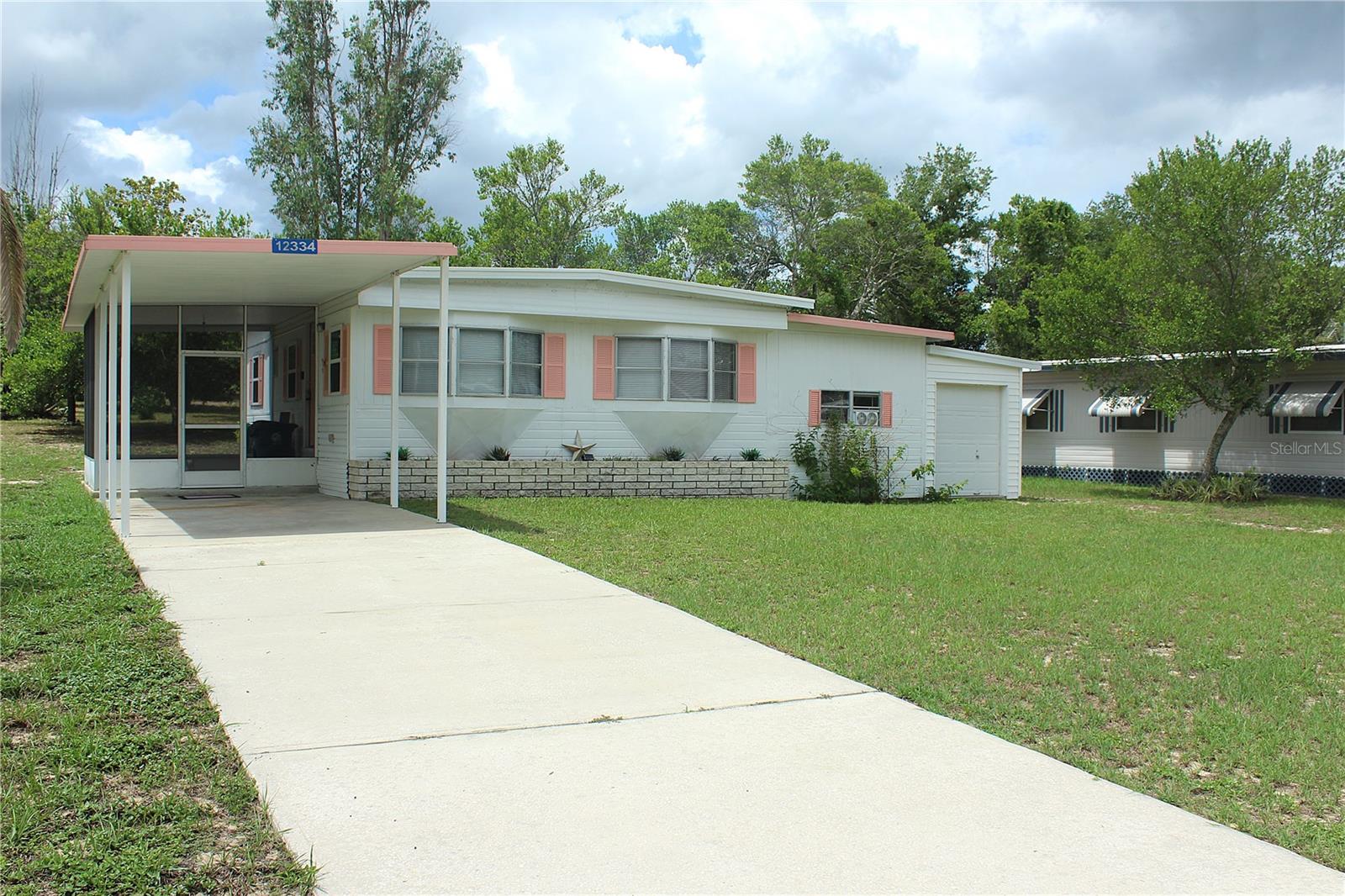 One or more photo(s) has been virtually staged. Florida Retirement Living at Its Finest! Welcome to the vibrant and active 55+ golf community of High Point, where Florida living meets exceptional value with an amazingly low HOA fee. This move-in ready 2-bedroom, 1.5-bath home is perfect for retirees looking to enjoy a relaxed and social lifestyle. Located on a quiet street with a private backyard view, this home offers updated comfort and functionality. Step inside to find newer vinyl plank flooring throughout the main living areas and ceramic tile in the bathrooms. The updated kitchen features ample cabinet and counter space and flows effortlessly into the dining and living areas—ideal for entertaining family and friends. The spacious primary bedroom includes a private half-bath, while a full hall bath serves guests and the second bedroom. A dedicated indoor laundry and storage room adds convenience, and there’s even a separate golf cart garage for your easy access to all community amenities. Enjoy the screened lanai patio, perfect for morning coffee or evening relaxation with views of your serene backyard. Major updates provide peace of mind, including a new vapor barrier (2024), electric panel (2023), and A/C system (2015). High Point offers something for everyone with amenities such as an 18-hole golf course, heated community pool, Tennis, shuffleboard, bocce ball, horseshoe courts, Clubhouse with a calendar full of activities and social events, Dog park for your furry friends and RV storage lot available for rent. This is more than just a home—it’s a lifestyle. Don’t miss your opportunity to be part of this welcoming and active community!