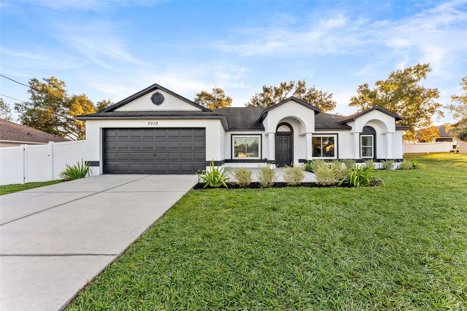 One or more photo(s) has been virtually staged. Welcome to 3010 Lackland Ave, a beautifully remodeled 3-bedroom, bonus room, 2-bath, 2-car garage home perfectly situated near Frank W. Springstead High School (0.5 mi) and Explorer K-8 School (1.2 mi)—making it an ideal spot for families who want short commutes and a quiet neighborhood feel.
This home offers custom upgrades galore, newer hurricane impact windows, Samsung appliances and whirlpool washer and dryer. Also featuring a thoughtfully redesigned kitchen and bathrooms that showcase craftsmanship and quality at every turn.Gorgeous chef’s kitchen with custom solid-wood cabinetry, quartz countertops, shiplap accents, open shelving, and a massive island perfect for entertaining.
Both bathrooms completely renovated, each with modern fixtures, dual vanity, shiplap walls, and timeless tile finishes that feel straight out of a designer magazine.
Open-concept living with vaulted ceilings, luxury vinyl plank flooring, and a built-in entertainment wall that anchors the spacious family room.
Abundant natural light throughout for a bright, airy feel.
Step out back to a fenced-in yard shaded by mature oaks—ideal for kids, pets, and outdoor gatherings. The yard includes a custom wooden playset with dual slides for weekend fun right at home! There’s also plenty of room to add a pool or garden in the future.
Located in a peaceful, family-friendly neighborhood just minutes from top schools, shopping, dining, Weeki Wachee springs, the Gulf and local parks—this home combines modern style, everyday convenience, and long-term value.