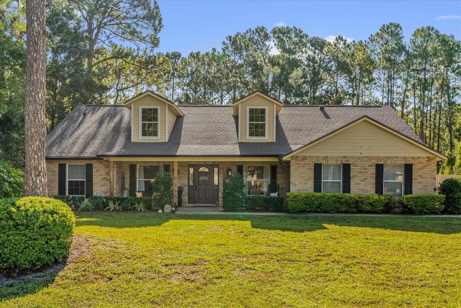 Welcome to this beautifully maintained, custom brick home nestled on a spacious half-acre lot in the highly sought-after St. John’s Woods community in DeBary. Offering 1,993 square feet of thoughtfully designed living space, this 3-bedroom, 2-bathroom residence also features a versatile flex room—perfect for a home office, den, or creative studio. Step inside to discover vaulted ceilings, tile flooring, and an open, airy atmosphere filled with natural light. The kitchen is a chef’s delight with stainless steel appliances, updated cabinetry and countertops, and a charming breakfast nook—ideal for casual meals and morning coffee. Entertain with ease in the separate dining room and spacious open-concept living area, or retreat to the private primary suite, which boasts a large en suite bathroom complete with a soaking tub and separate shower. The split floor plan ensures added privacy, with two additional bedrooms and a full bath located on the opposite side of the home. Enjoy the best of Florida living on the expansive screened-in patio, or fire up the grill in the outdoor gazebo area, surrounded by peaceful views of the lush, tree-lined yard. The backyard borders a protected nature area that will never be developed, offering a serene backdrop of local wildlife—including the occasional deer. A fully fenced yard makes this a great space for pets, and the mature landscaping adds even more charm and curb appeal. Additional highlights include a 2-car garage, newer roof, updated AC system, hot water heater, and gutters with leaf guards—providing peace of mind for years to come. Located just minutes from the scenic St. John’s River, a public boat ramp, and the popular Swamp House restaurant, this home also offers easy access to Orlando and Florida’s stunning Atlantic beaches—both less than 30 minutes away. If you’ve been dreaming of the perfect blend of country charm and modern convenience, this delightful home is ready to welcome you.