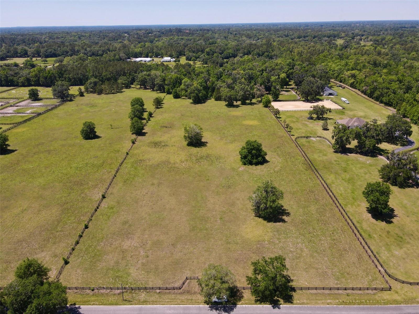 Tucked away on a beautifully canopied and quiet street in the heart of Ocala’s prestigious NW horse country, this 10+ acre property offers the perfect blank canvas to bring your dream farm to life. Surrounded by some of the area’s top training facilities and competition venues, you’ll be ideally positioned between the World Equestrian Center (8.5 miles) and HITS (4 miles). With an additional 10+ acre neighboring parcel available, there’s flexibility to build exactly what you need—whether that’s a private training operation, a peaceful retreat, or a world-class equestrian facility.