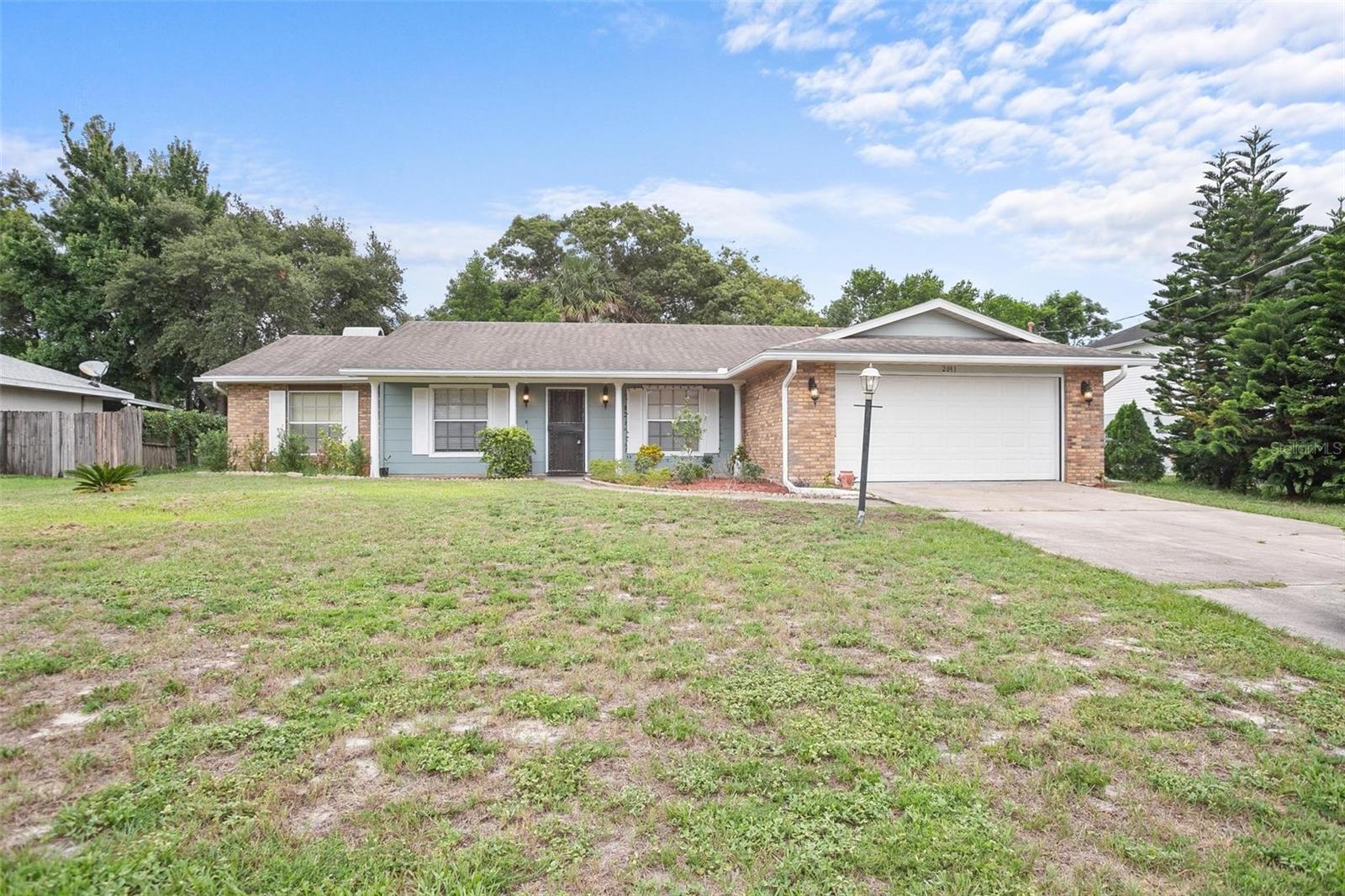 BEAUTIFUL BLOCK HOME CONVENIENTLY LOCATED IN A QUIET HIGHLY SOUGHT-AFTER NEIGHBORHOOD OF DELTONA LAKES! This home has an open floor plan (optional office being used as a 3rd bedroom that has a fireplace and glass sliding doors leading out into the expansive sunroom, where the whole family can enjoy games, tv, and movies)! Come experience the modern comfort this home has to offer, fresh new paint, elegant tile floors and granite countertops in the bathrooms as well as in the well-appointed kitchen. This home also features a spacious double car garage, Step Outside and enjoy the fully fenced backyard—perfect for pets, play, or hosting a summer BBQ. Whether you're gardening, relaxing, or letting the kids roam free, this outdoor space is both private and practical.There is also a large outdoor shed for storage!