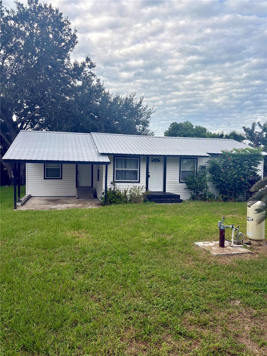 Welcome to this mid-century gem in Bartow’s Braswell Addition! Country living with no HOA.
This single-story, 2-bedroom, 1-bath home is brimming with character and opportunity. Originally built in 1956, it gives you the chance to retain that vintage charm while creating a refreshed space tailored to your tastes.
The added sitting area also functions as a 3rd bedroom if needed. Additional updates include a new deep well (2021), metal roof (2012), and updated electrical and plumbing. New LPV flooring in living room 2025.
The spacious bathroom features a walk-in shower and washer and dryer hookup. Other features include covered carport and backyard shed. This is a great starter home or investment property. Don’t wait finding a home for this price in Polk County Fl is hard.