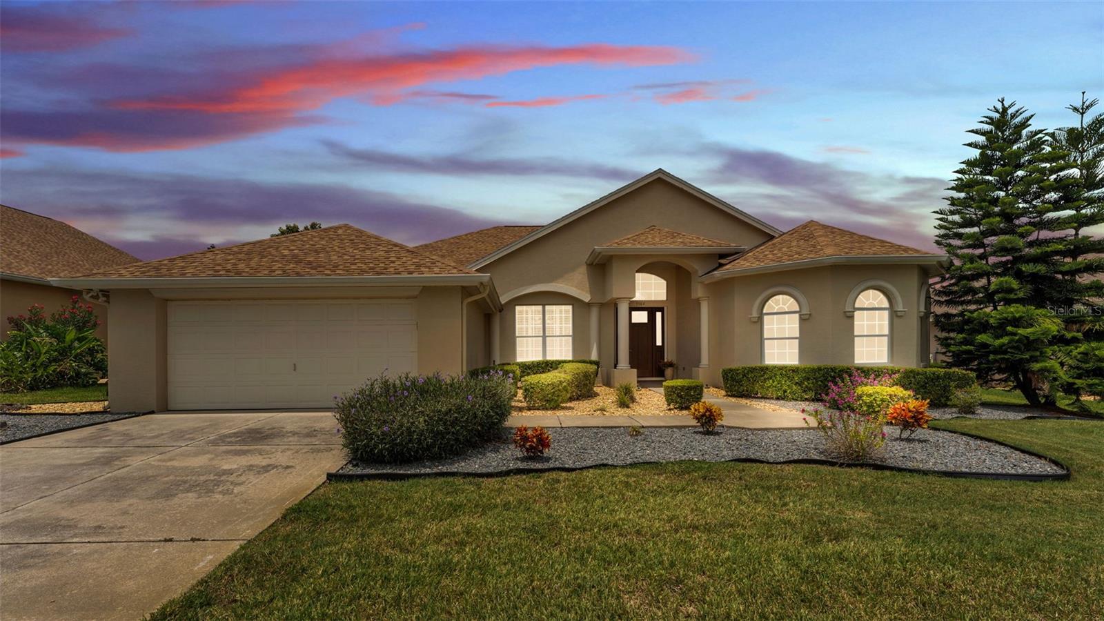 Step into effortless Florida living with this refreshed 3-bedroom, 2.5-bath home, where an open split floor plan, high ceilings, and "wood" floor tiles create an airy, welcoming feel from the moment you enter. A carpeted wing tucks the secondary bedrooms away for privacy, while the palatial primary suite offers spa-like indulgence with a garden tub, separate shower, and dual vanities. In the heart of the home, the eat-in kitchen pairs everyday ease with plenty of space for gathering, and a coated garage floor keeps things neat and bright. Outside, lush landscaping frames a fully fenced back yard—ideal for play or pets—while an enclosed patio provides front-row seats to glowing sunsets over the neighborhood green space. With a new refrigerator, water heater(2024), roof (2021) and A/C(2024) already in place, this move-in-ready retreat sits minutes from Lake Hollingsworth’s scenic trail, Barnett Family Park, and the dining and shopping of downtown Lakeland, with Orlando and Tampa an easy commute in either direction. Come make this inviting residence your next address before someone else does.