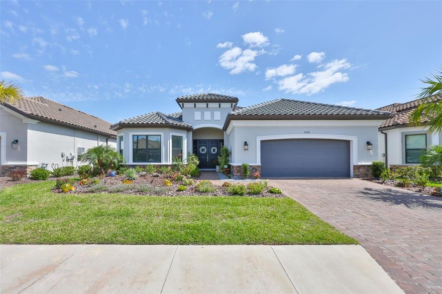 Welcome to the essence of Florida living in this meticulously maintained, beautifully appointed, nearly new Palazzio model, offering over 3,000 square feet of thoughtfully designed living space in the highly sought-after Esplanade at Artisan Lakes. Step through the elegant double-door entry and immediately experience the home's inviting ambiance, highlighted by soaring ceilings, abundant natural light, and a wide-open floor plan that delivers an impressive "wow" factor. Upgraded recessed LED lighting and designer ceiling fans are featured throughout, while a striking chandelier creates a sophisticated and welcoming first impression. Barely two years old, this three-bedroom, three-bath residence seamlessly blends architectural elegance with modern design, offering the perfect balance of luxury, comfort, and functionality. The home showcases luxury vinyl plank flooring throughout the main living area, 10-foot ceilings, 8-foot interior doors, crown molding, and tray ceilings. Designed for both everyday living and effortless entertaining, the open-concept layout flows beautifully between the gathering room, dining area, and gourmet kitchen. The chef's kitchen serves as the heart of the home, featuring upgraded cabinetry, a spacious center island, Italian porcelain tile backsplash, and a walk-in pantry. The owner's suite offers a private retreat with elegant bay windows and a spa-inspired ensuite bath, complete with dual vanities, a walk-in shower, a private water closet, and a custom walk-in closet with thoughtfully designed built-ins. Bedroom two functions as a true secondary suite with its own private bath and generous closet, while bedroom three is equally spacious and well-appointed. A versatile flex room with designer glass double doors provides the ideal space for a home office, library, den, or media room. Additional highlights include a well-appointed laundry room with built-in cabinetry for added convenience and storage, and a 4-foot extended garage complete with pro-grade polyaspartic flooring and overhead storage. Embracing Florida's indoor-outdoor lifestyle, a dramatic 12-foot pocket sliding glass door opens to an oversized covered and screened lanai, pre-plumbed for a full outdoor kitchen and fireplace, creating a stunning outdoor retreat. There is also ample space to design and build your dream pool! Living in Esplanade at Artisan Lakes offers a true resort-style experience within a beautifully planned community. Residents of this gated enclave enjoy access to an array of world-class amenities centered around a luxurious clubhouse, complemented by a full-time lifestyle director who curates engaging social events and activities. Amenities include a resort-style pool and spa, a resistance pool, a state-of-the-art fitness center, aerobics and dance studio, day spa with massage rooms, tennis, pickleball and bocce courts, gathering spaces, a catering kitchen, fire pit lounge, scenic walking and biking trails, and a dedicated dog park. Ideally located with convenient access to Interstate 75, you're just a short drive from Tampa, St. Petersburg, Sarasota, and the pristine Gulf Coast beach. Experience the perfect blend of lifestyle, space, and elevated design this exceptional home offers. Schedule your private showing today.