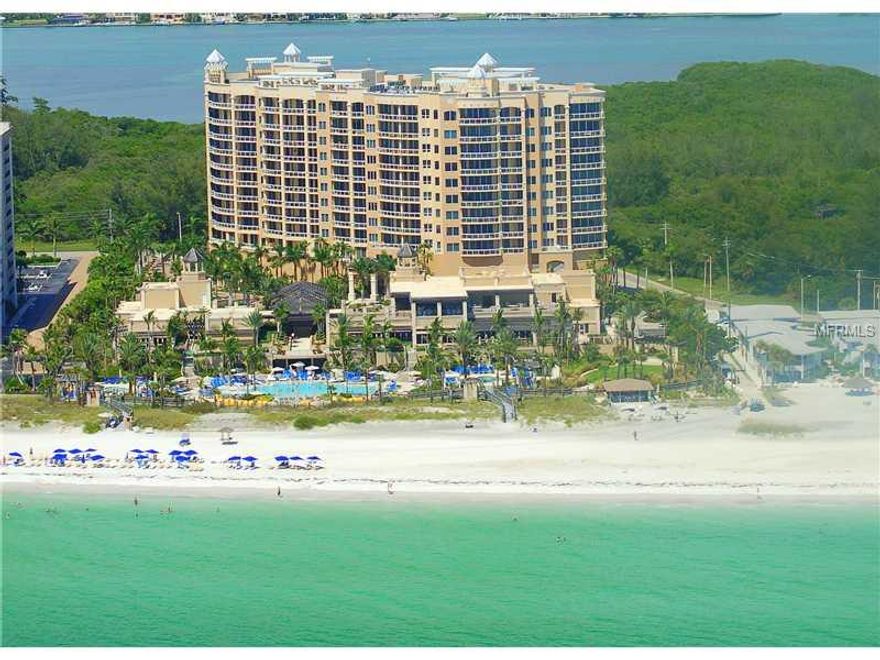 Ultimate CHOICE LOCATION! This residence has it all!  Walls of glass and Southwest corner with forever  sunrise and sunsets views! Picturesque panoramas  of the Gulf, Bay, Sarasota skyline and nature preserve envelop this meticulously designed 3 bdrm plus family room residence with endless upgrades. The ultimate in elegance and upgrades, gas fireplace,  with marble and wood flooring throughout,  custom gourmet kitchen with upgrade,  a European flavor. Two spacious terraces and only the finest appointments available. Live the Ritz lifestyle with amenities including private owner's pool & spa, social room, billiard room, kitchen, theater with tiered seating, massage facilities, maid services and 24 hour full concierge and room service. Maintenance fee covers building exterior, cable, escrow reserve funds, electric bill for common area, flood insurance, ground maintenance, building insurance, maintenance and repairs, manager, public insurance, recreational facilities, roof, security, trash removal and water and sewer. Just minutes to St. Armand's Circle! TWO parking spaces plus air conditioned storage. TWO pets welcome no weight limit! When comparing this building to other buildings please note this is built to the newest hurricane code with newer windows!