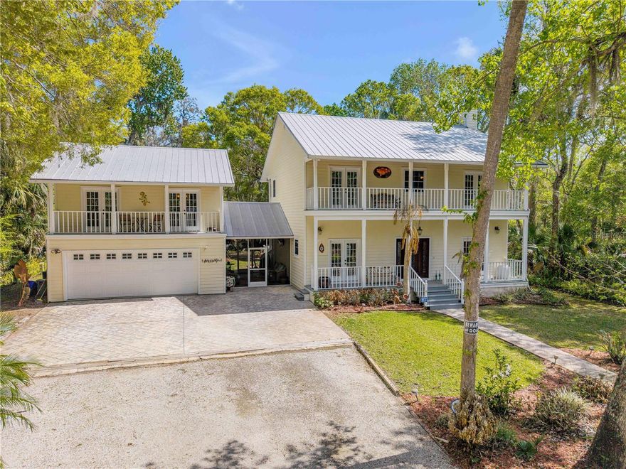 Tucked on over 2 acres and beneath a canopy of mature trees and lush native foliage, this must see serene custom pool home offers the perfect blend of privacy, charm, and thoughtful design. The property features a spacious 3-bedroom, 2-bath main residence along with a separate 1-bedroom studio guest house or in-law suite, creating an ideal setup for extended family, guests, or potential rental income. Dripping with classic Southern charm, the home welcomes you with sweeping porches and balconies that provide the perfect setting for relaxing with a cold drink on a warm Florida afternoon. From top to bottom, the home was designed with both durability and efficiency in mind, featuring a Galvalume metal roof, Hardie board siding, fiberglass lifetime exterior doors, and enhanced insulation. Inside, the bright and open first floor showcases beautiful pine flooring that flows through the living spaces, all filled with natural light. The chef’s kitchen is both elegant and functional, featuring tile flooring and premium stainless-steel appliances including a Viking six-burner gas range with hood and double oven. A large island with granite seating comfortably accommodates four and provides additional prep space with a built-in sink, making it perfect for entertaining or everyday living. The owner’s suite is a peaceful retreat highlighted by a cozy gas fireplace and private French doors that open to a second-story balcony overlooking the tranquil grounds. The spa-inspired bathroom features dual sinks, a walk-in closet, a spacious walk-in shower, and a separate soaking tub designed for ultimate relaxation. Two additional bedrooms connected by a Jack-and-Jill bathroom complete the second floor. French doors throughout the home open onto inviting wood decks, creating seamless indoor-outdoor living spaces perfect for entertaining, sunbathing, or simply enjoying the expansive yard shaded by mature trees and natural vegetation. An outdoor shower adds convenience after a swim or a day at the nearby beach. The screened pool area serves as a private backyard refuge, offering peaceful privacy surrounded by nature. Just steps away, a second charming screened sitting area leads to the second-story studio guest house, which includes a bedroom, full bathroom, and full kitchen. With its private setting separate from the main house, the studio is ideal for guests, or extended family. Additional highlights include a large two-car garage, two separate central HVAC systems for the main home (upstairs and downstairs) and three hot water heaters to comfortably support the entire property. Though hidden away, this home is conveniently located near parks, beaches, shopping, and dining, with easy access to both New Smyrna Beach, Edgewater, and Interstate 95. This unique property combines comfort, character, and versatility, making 2101 Knittle an exceptional place to call home.