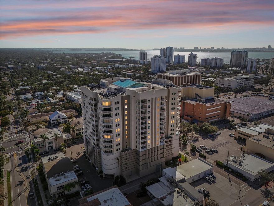 Priced under current Appraisal Report. Report available to qualified Buyers. Discover the ultimate in contemporary living with this rarely available northwest corner unit on the 10th floor of Rivo at Ringling. This iconic residence promises a luxurious lifestyle, boasting extensive concierge services and an amenity-rich level that includes a pristine pool, a state-of-the-art fitness center, and secure parking.

Upon entering, you're greeted by a welcoming generous foyer that effortlessly guides the eye through the expansive living area. The highlight? An impressive 16-foot sliding glass wall that opens onto a stunning 20’ x 9’ terrace, showcasing enchanting views over the city, the islands, and verdant landscapes.

Enjoy vistas of Main Street and beyond, admiring diverse architectural styles juxtaposed with tree canopies and water views. The panorama also stretches through Big Pass to the Gulf of Mexico, extending to Siesta Key to the south and northerly to Sarasota Bay.

The open-plan great room is a delight, offering ample space for casual seating and formal dining, all while being immersed in the beauty of the outdoor scenery and the evening's twinkling lights.

The master suite is a private haven, featuring a custom walk-in closet and an en-suite bath adorned with a double-size vanity, a granite countertop, a spacious walk-in shower surrounded by chrome-framed glass, and a luxurious soaking tub.

The thoughtful split-bedroom design offers additional seclusion, with two additional bedrooms providing captivating views of the city and water. A full bathroom boasts a shower/tub combination accented with a quartz countertop and a chic vessel sink.

Abundant closet space and a dedicated full-size laundry room add to the well-planned functionality of the home. Recent upgrades include a new Rheem water heater ( 2022) and a Trane air conditioner (2024).

The property's secure gated parking garage with two private spaces ensures stress-free parking. Rivo at Ringling delivers vibrant urban living within an architectural masterpiece built around an atrium bathing the interiors in natural light and adorned with lush indoor landscaping.

Positioned perfectly to enjoy all that downtown Sarasota has for you to enjoy, while remaining a serene escape from the bustle, it is only a quick free trolley ride to stunning beaches and within a quick walk to fine dining, boutique shopping, and entertainment.

On the third floor, residents are treated to luxurious amenities including a heated pool and spa with sundeck, a BBQ area, a modern gym, a social room, friendly on-site management, a convenient bike room, and a kayak rack.

Redefining urban sophistication, Rivo at Ringling stands as a testament to iconic style, with fully funded reserves ensuring peace of mind and a vibrant social calendar that enriches community life.