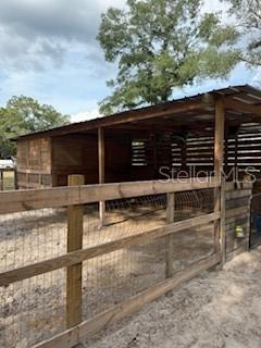 This beautiful property features a four-stall barn complete with a tack room and a storage area. It's fully fenced with no-climb wire and two-board fencing, and there's a gate at the entrance. The property has a well with five-automatic waterers-one in each stall and one in the field. It's divided into a dry field and a grassy field, and it comes with electricity and Wi-Fi. The land is fully cleared, and all amenities are in place except a septic tank. It's perfect for building a home or bringing in a mobile home, or RV. Bring your toys because there is lots of space to tour and ride. Close to Florida's National Forest.